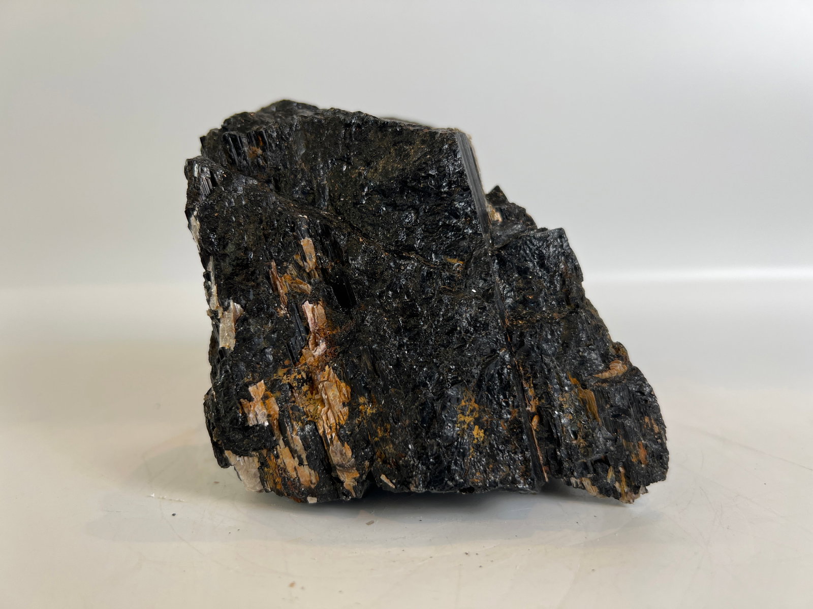 Black Tourmaline and Golden Mica Formation: Black tourmaline and golden mica formation. 3.5" x 3.5" x 3". 2 pounds, 13 ounces.