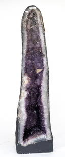 Huge Amethyst Cathedral Geode: Huge amethyst cathedral geode with fluorescent calcite crystals. 36"H, 9"W, 11"D. 97 pounds, 3 ounces.
