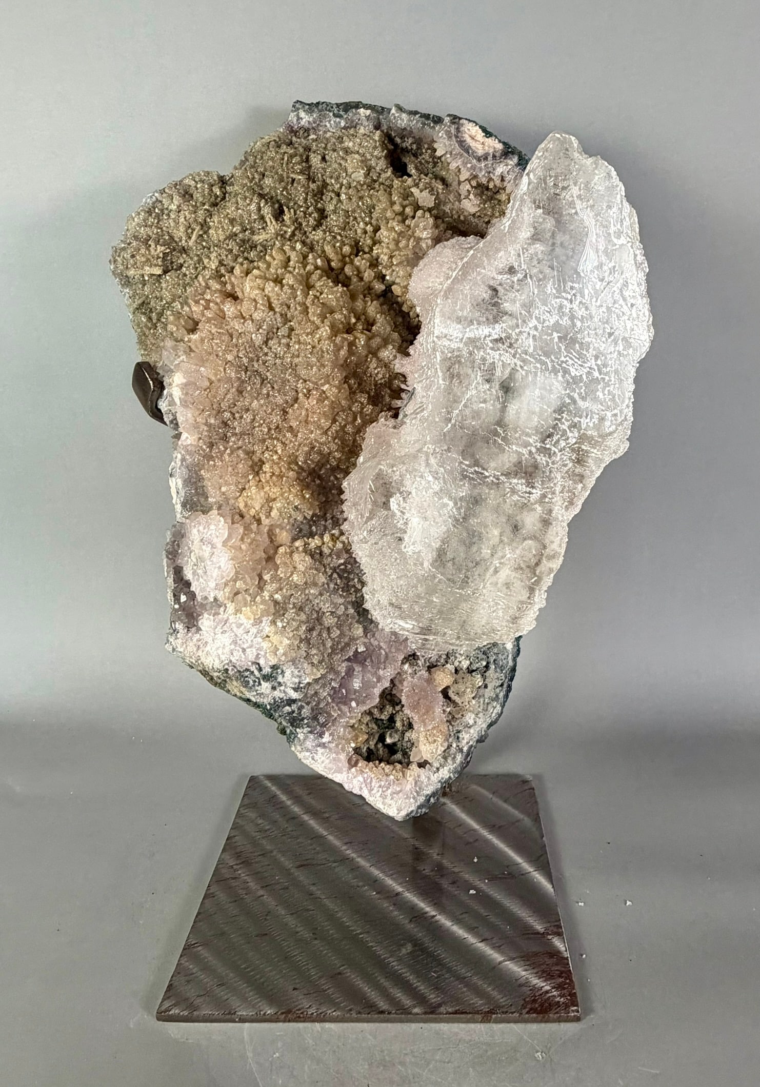 Amethyst and Selenite Formation on Custom Stand: Large amethyst plate with huge selenite crystal protrusion on custom steel stand. A rare and unique piece. 20.75" x 13" x 10". 57 pounds.