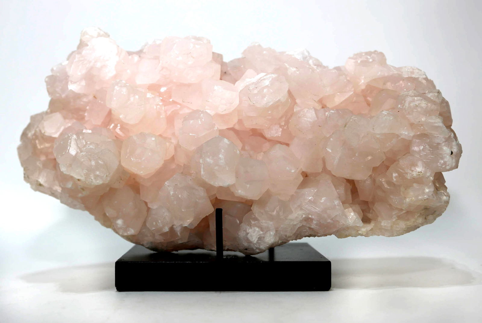 Large Pink Mangano Calcite Formation: Large pink Mangano calcite formation. Highly fluorescent. 6.25" x 13.5" x 5". 20 pounds, 10 ounces.