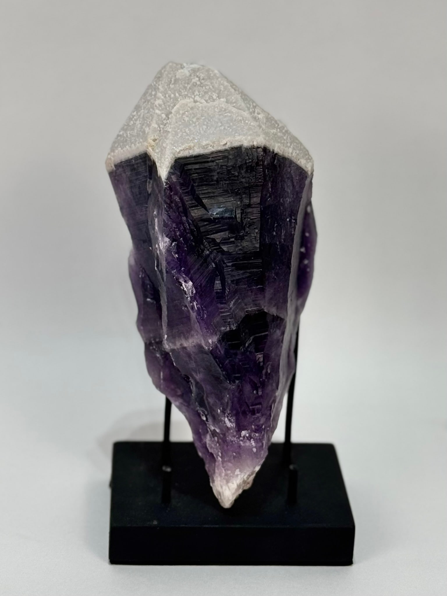 Super Rare Atomic Amethyst Crystal Point: Super rare atomic amethyst crystal point from India. Quartz crystal coating. Internal starburst pattern. 8” x 4” x 2.75”. 2 pounds, 11 ounces.