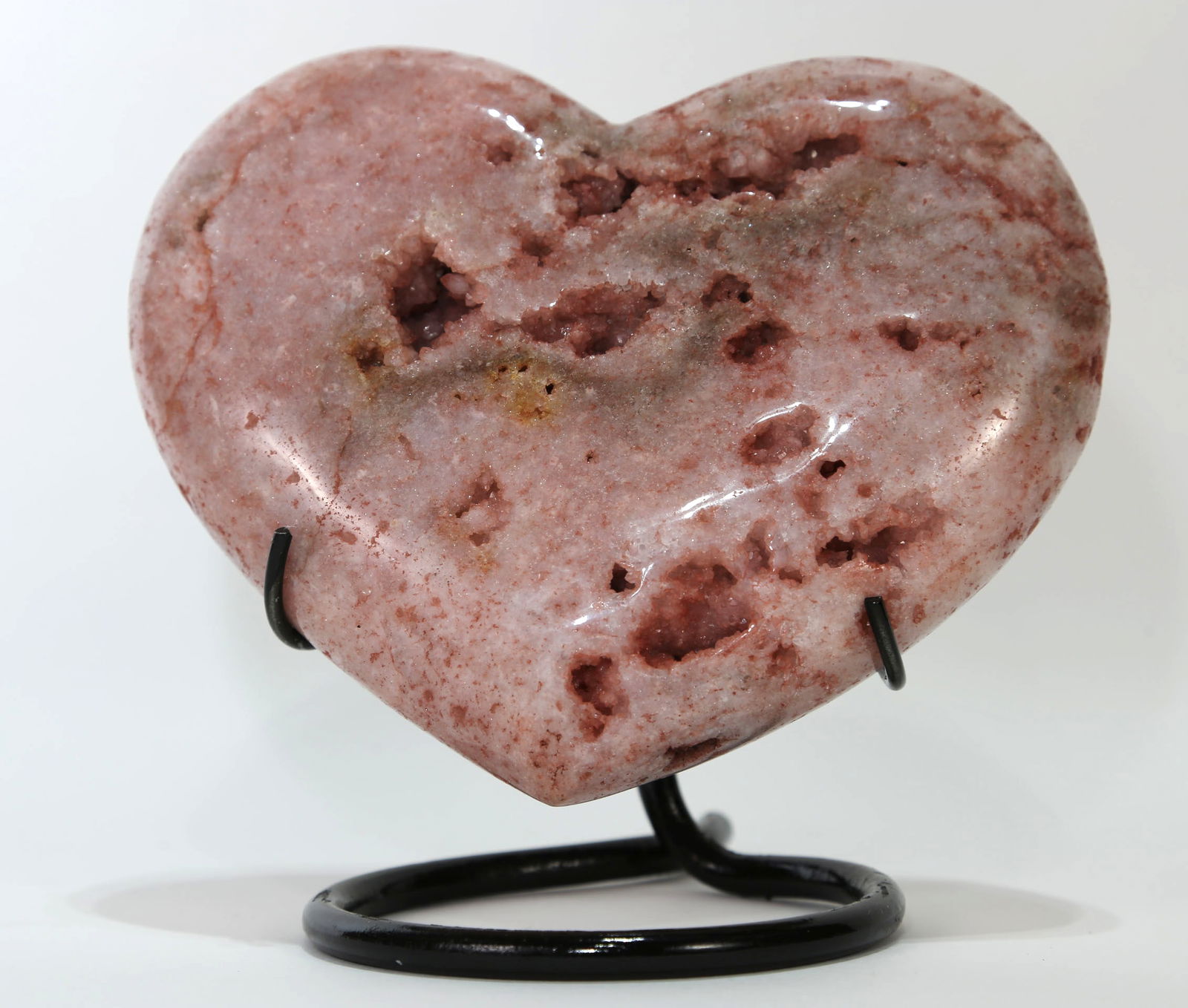 Pink Amethyst Heart on Stand: Pink polished amethyst heart on black metal stand. 7” x 7.25” x 4”. 4 pounds, 10 ounces.