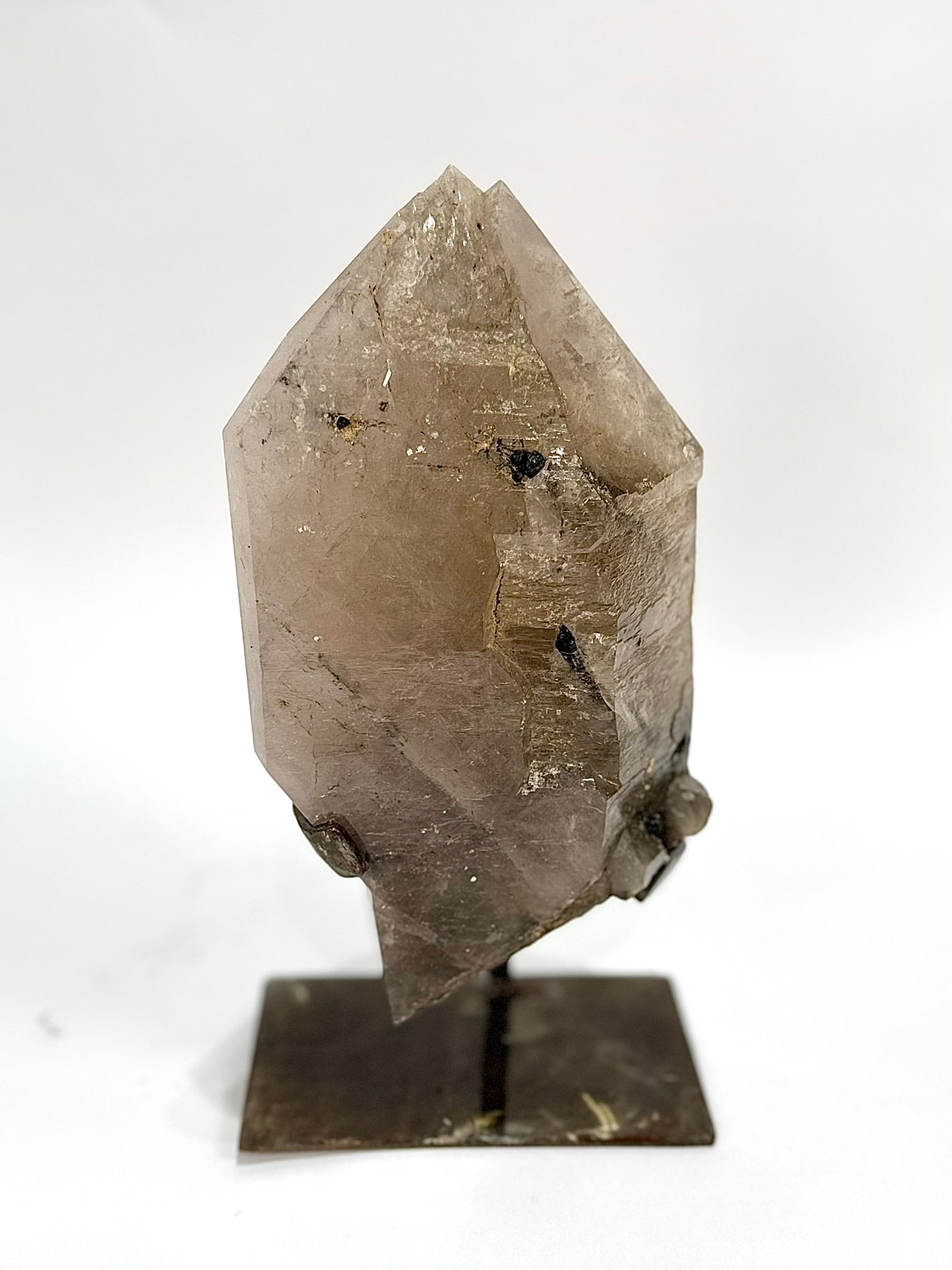 Tourmalinated Quartz Point on Stand: Double-terminated, tourmalinated quartz point on custom stand. 11.5" x 6" x 4". 7.60 pounds.