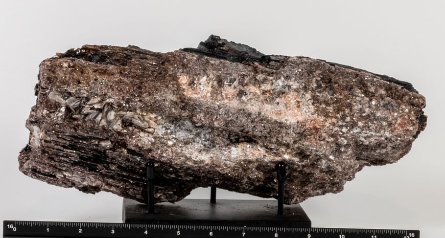 Large Black Tourmaline and Golden Mica Specimen: Large black tourmaline and golden mica specimen. 5.25 x 12.75 x 3.75 inches. 13 pounds, 3 ounces.