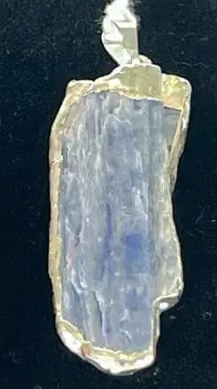 Blue Kyanite Pendant: Blue kyanite pendant with silver-colored plating on edges.
