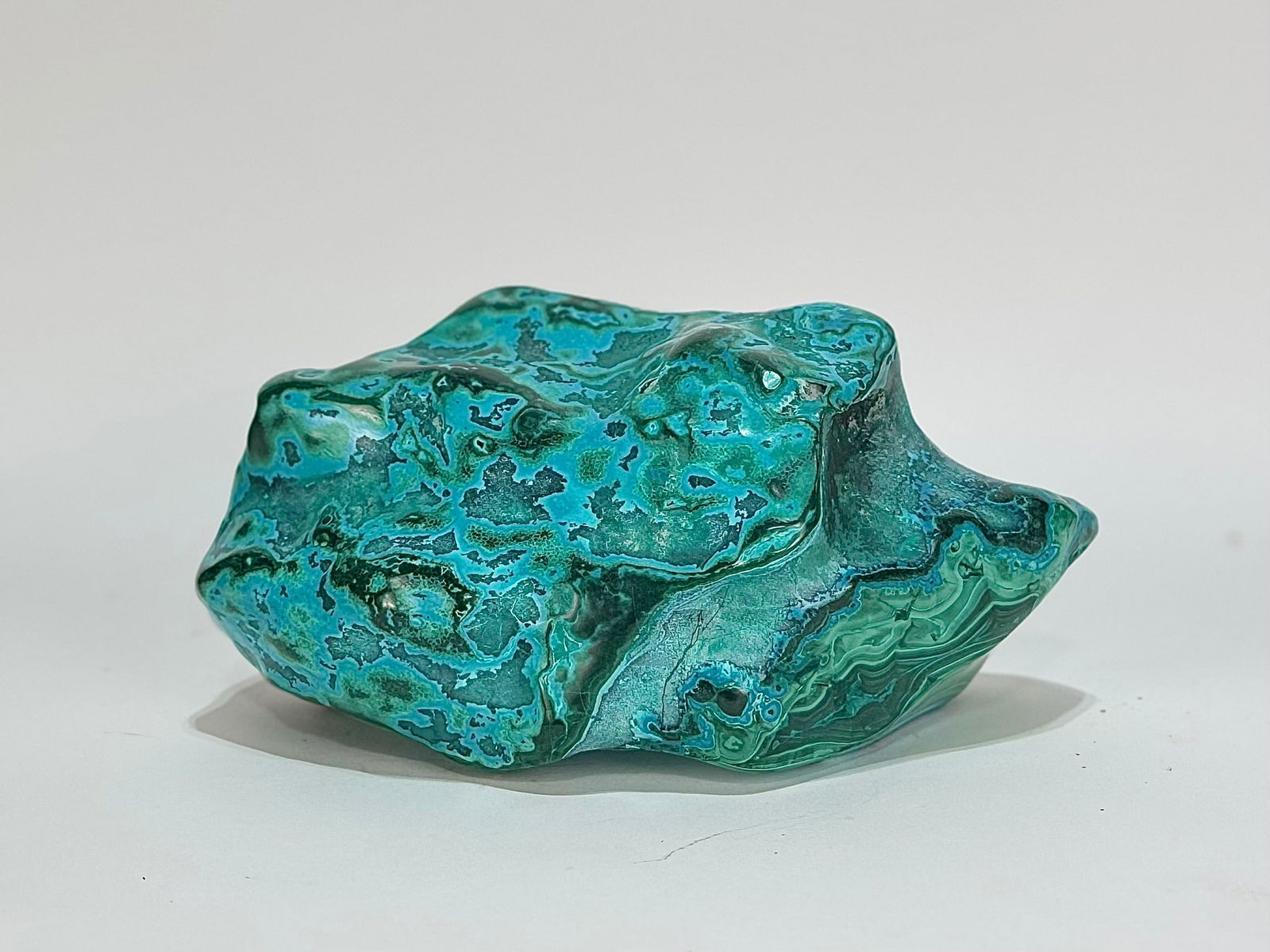 Polished Malachite and Chrysocolla Formation: Polished malachite and chrysocolla formation from the DR Congo. 5.5” x 6.5” x 3.25”. 4 pounds, 14 ounces.