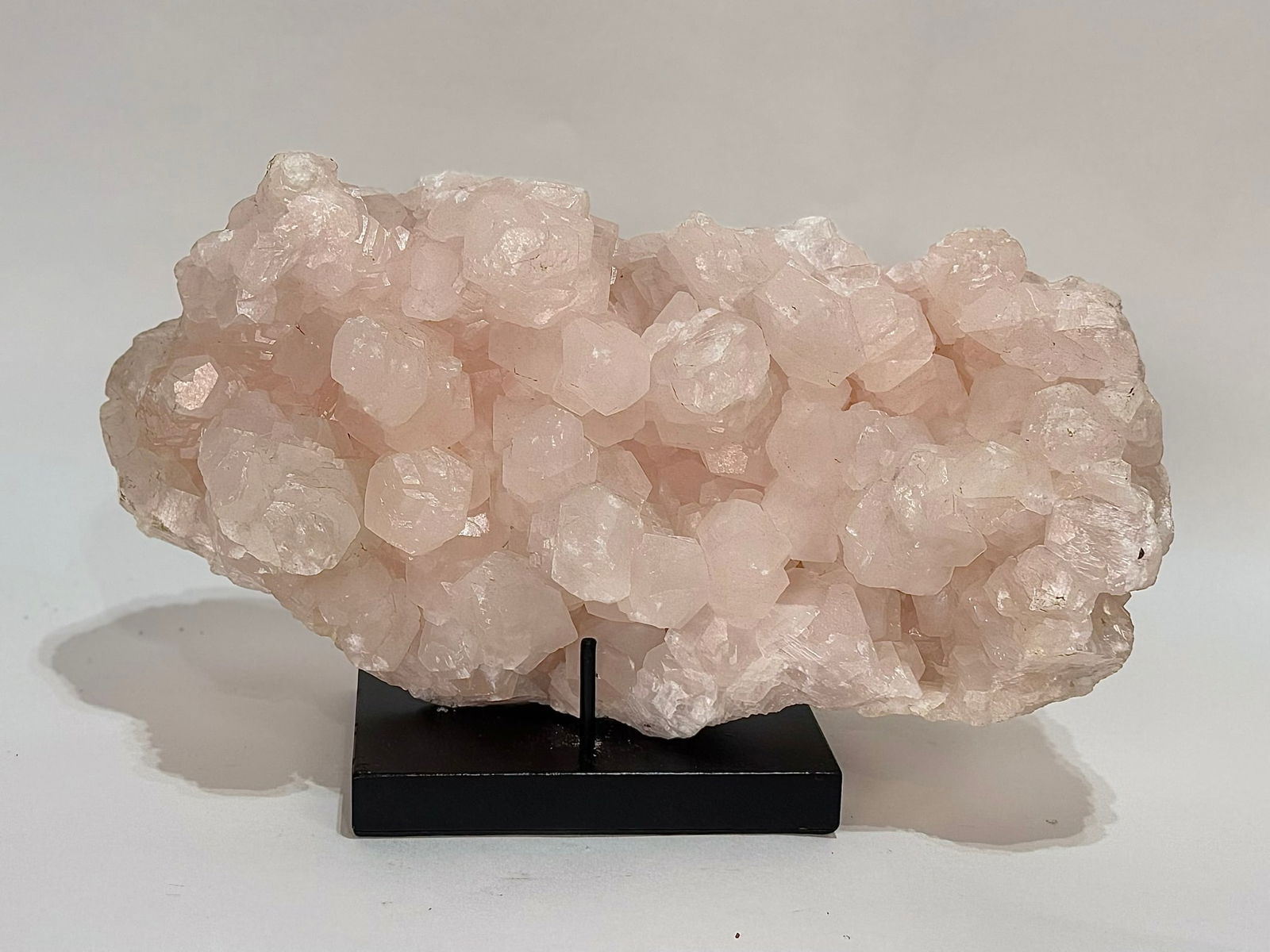 Large Pink Mangano Calcite Formation: Large pink Mangano calcite formation. Highly fluorescent. 6.25" x 13.5" x 5". 20 pounds, 10 ounces.