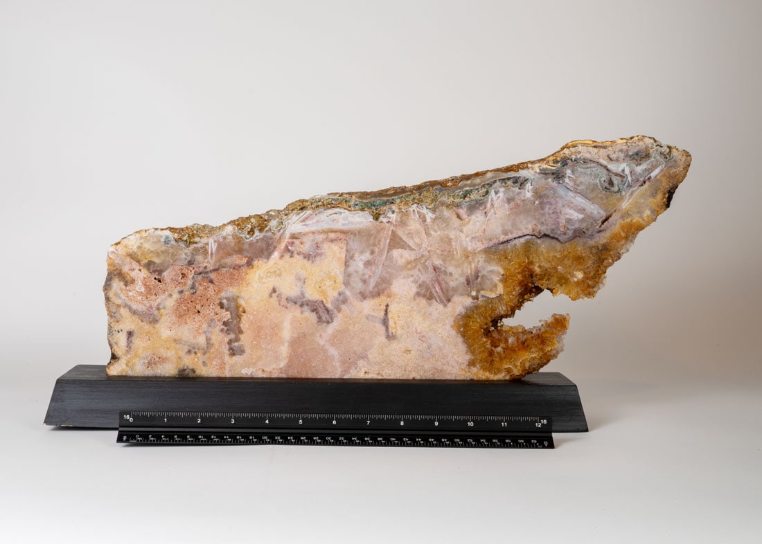 Pink Amethyst Shark on Wood Stand: Polished pink amethyst shark-shaped slab on wood stand. 9" x 20" x 3". 9 pounds, 1 ounce.