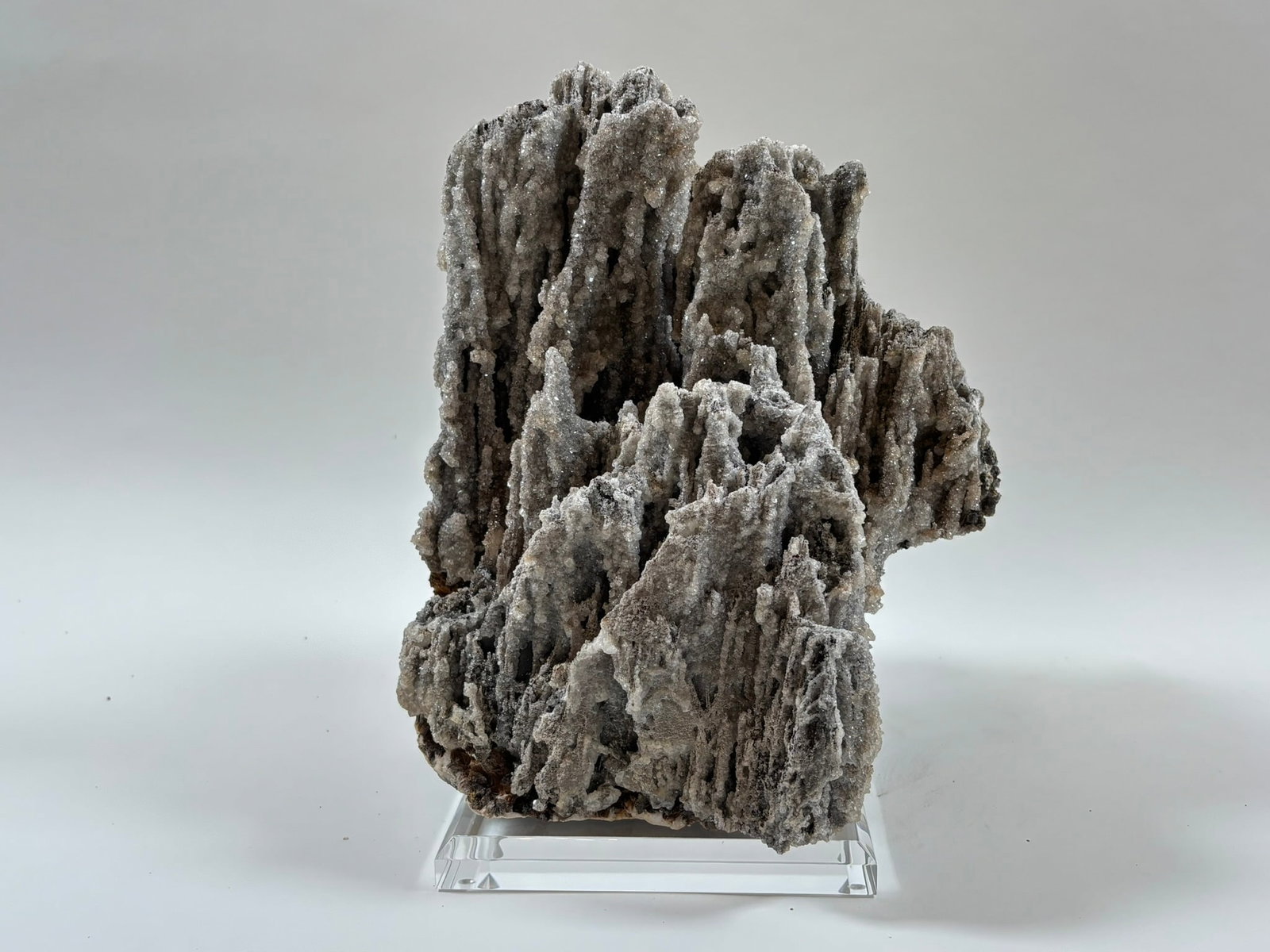 Calcite Stalactite Formation on Lucite Stand: Rare and unique calcite stalactite formation with different colored stalactites on custom lucite stand. 11" x 9" x 9". 17 pounds, 4 ounces.