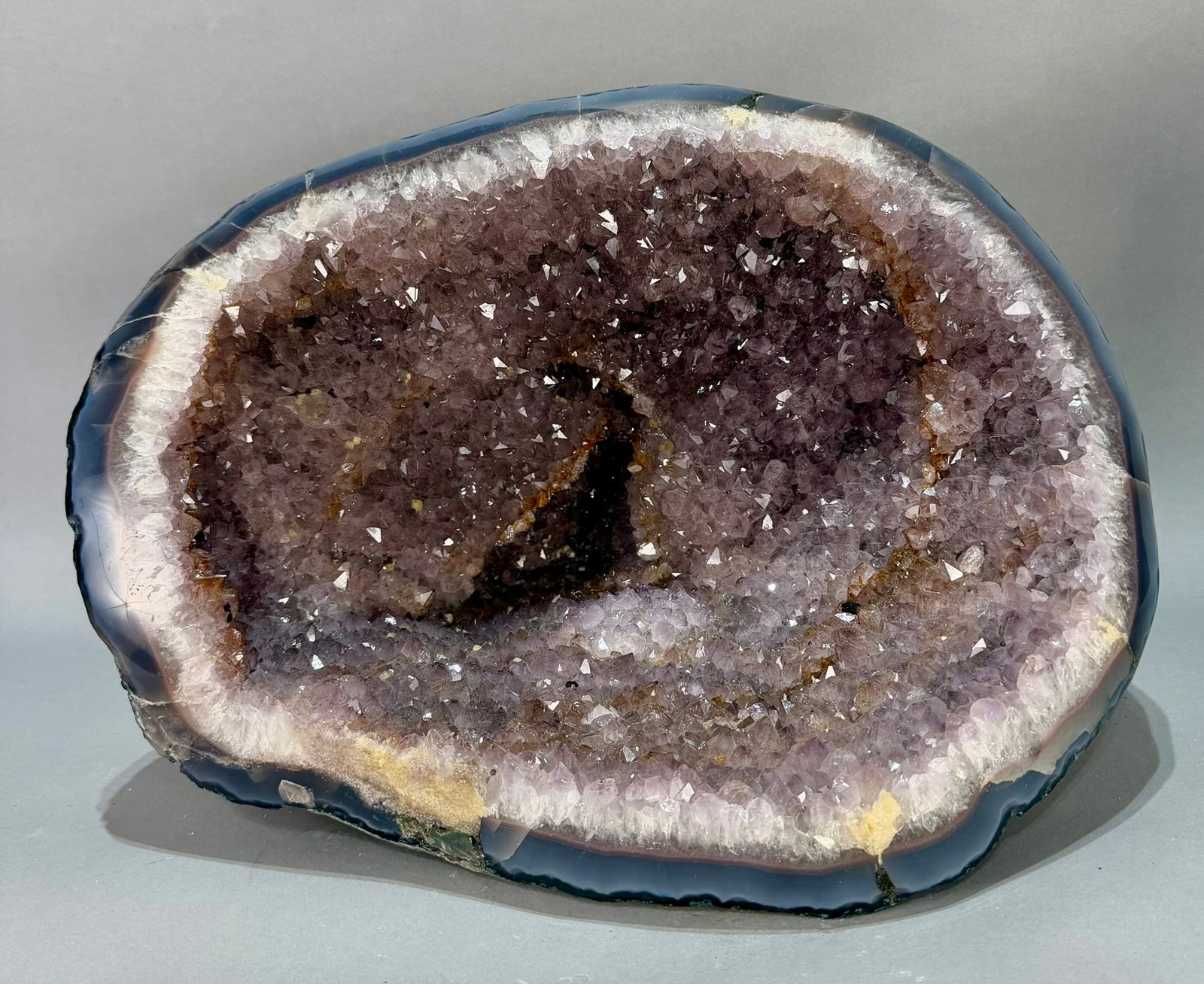 Large Amethyst Vug Geode With Orange Crystals: Beautiful amethyst vug geode with a smattering of orange crystals. 15.5" x 13" x 10.5". 37 lbs, 7 oz.