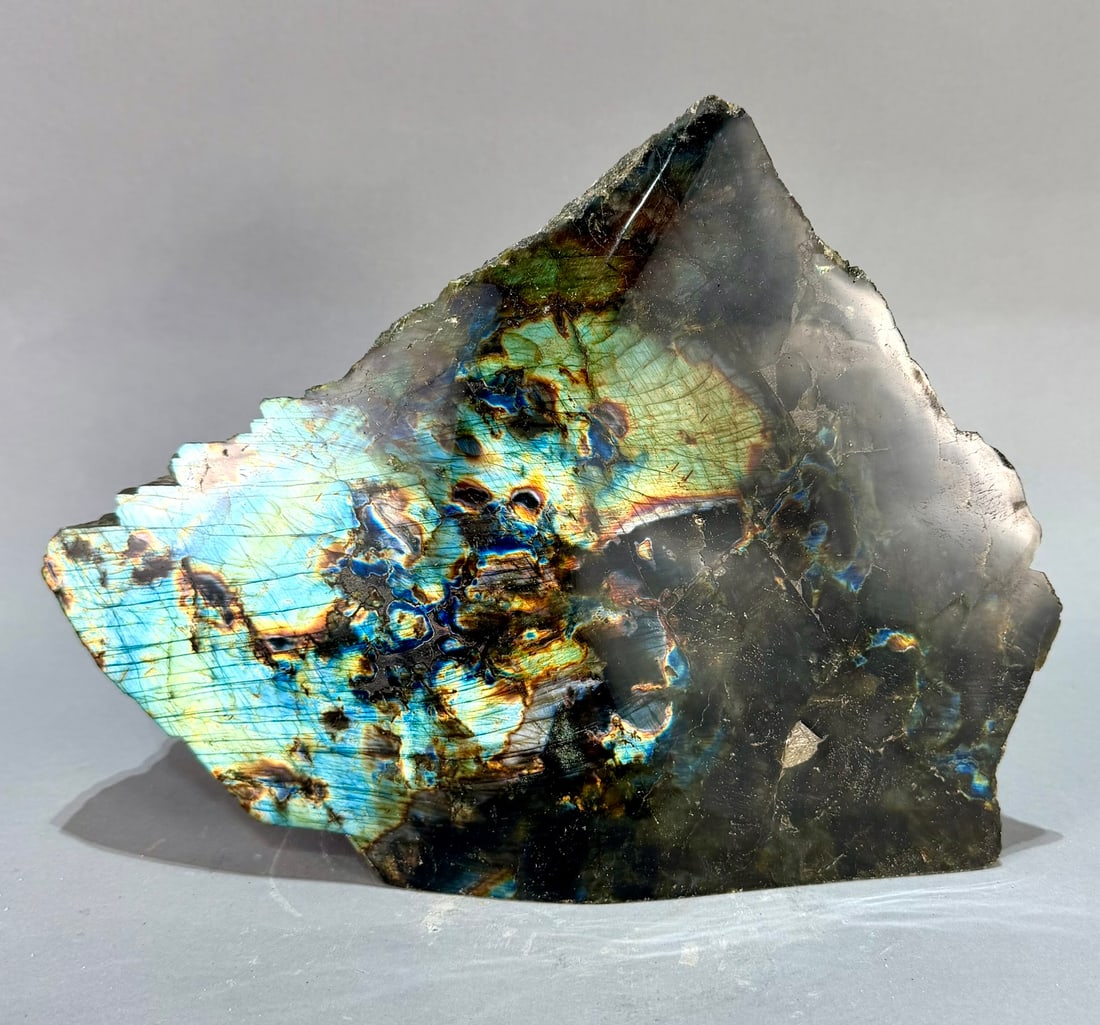 Live Edge Spectrolite Freeform: Large, live edge, front-polished spectrolite freeform from Madagascar. 8.75" x 12” x 4". 14 lb, 15 ounces.