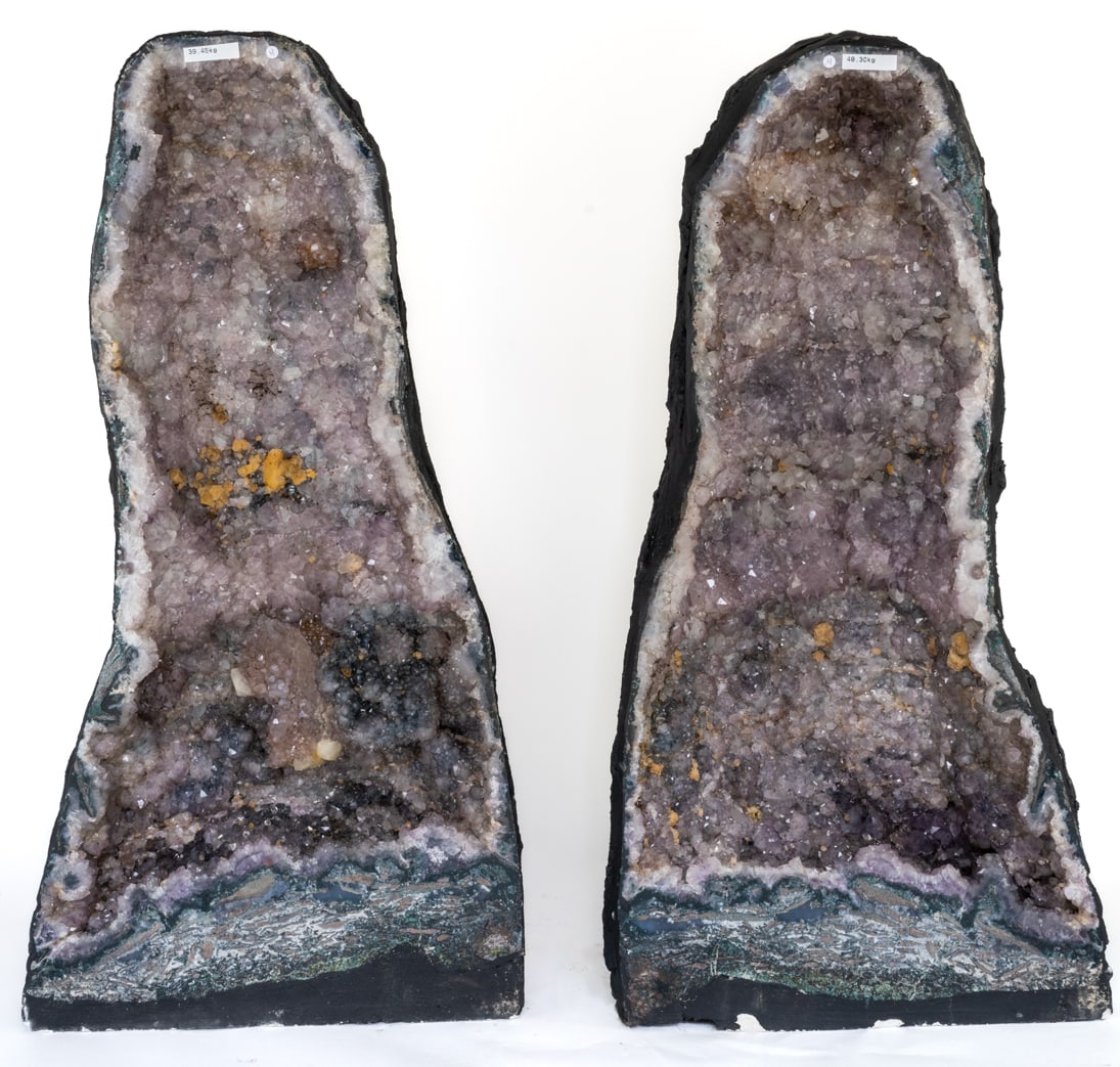 Huge Amethyst Cathedral Geode Pair: Huge amethyst cathedral geode pair with fluorescent calcite deposits. 30"H, 15"W, 8"D and 30"H, 15"W, 8.5"D, respectively. 193.45 lbs total weight.