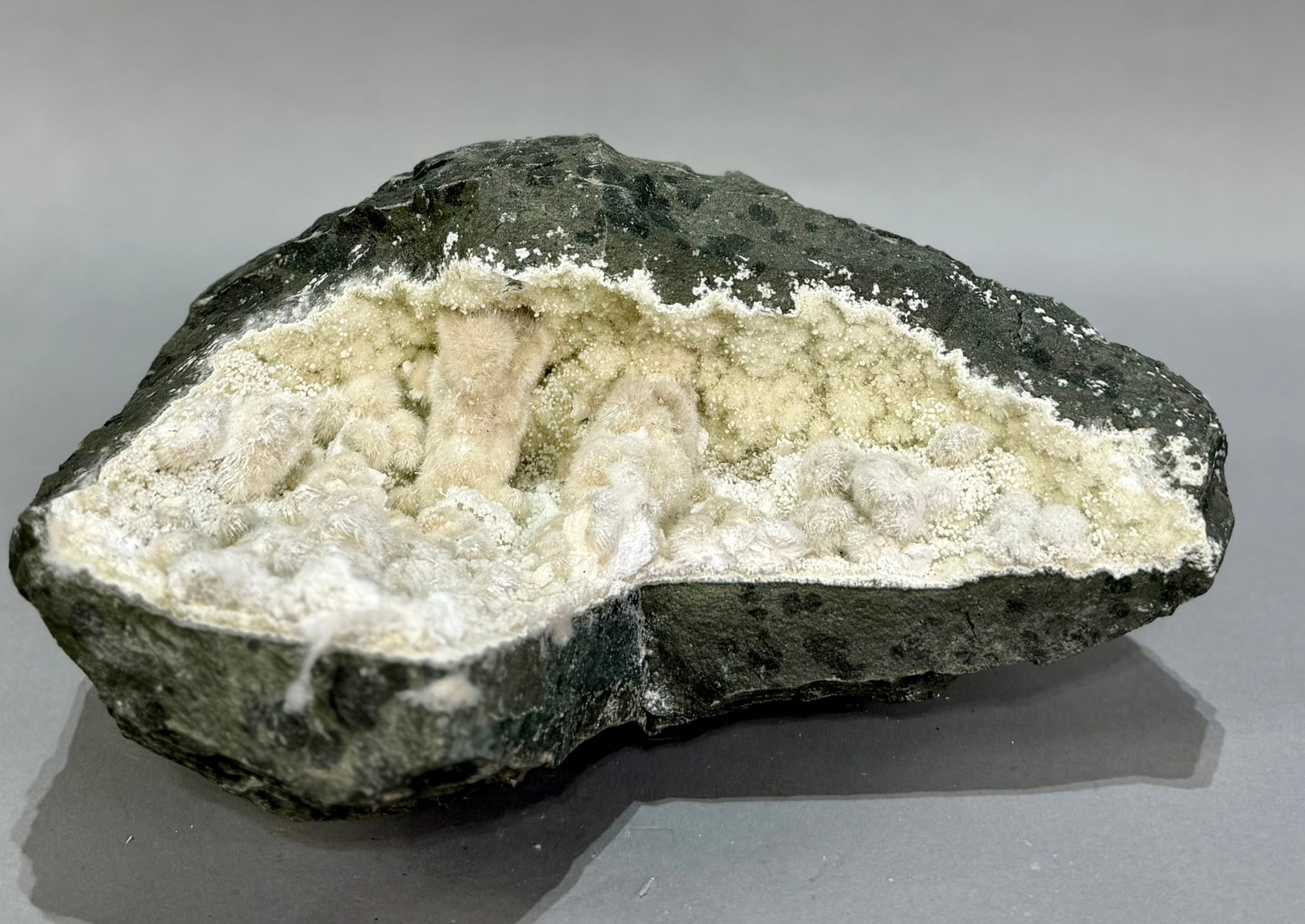 Large Okenite and Prehnite Geode: Large okenite and prehnite geode from the Malad Quarry in India. 6” x 11” x 7”. 14 lbs, 6 oz.