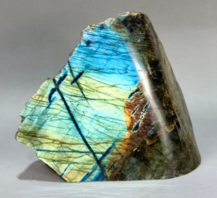 Live Edge Labradorite Freeform: Large, live edge, front-polished labradorite freeform from Madagascar. 8" x 9.25” x 4". 13 lb, 12 ounces.