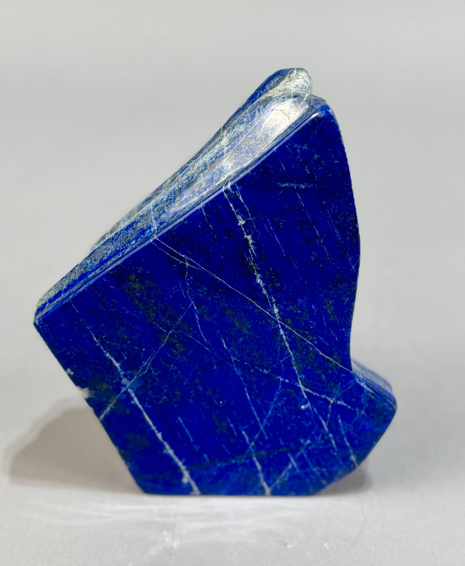 Polished Lapis Lazuli Freeform: High grade, finely polished lapis lazuli freeform from Afghanistan. 7” x 5.5” x 1.75”. 4 lbs.