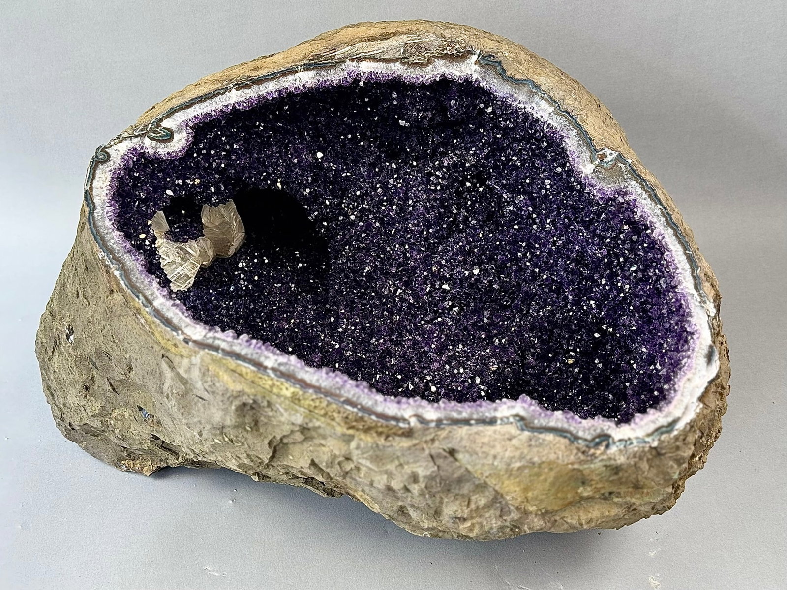 122 Pound Uruguayan Amethyst Geode WIth Large Calcite Crystal - MONUMENT: 122 pound truly exceptional dark amethyst geode with large calcite crystal from Uruguay. 17" x 20" x 13". 122 lbs, 6 oz.