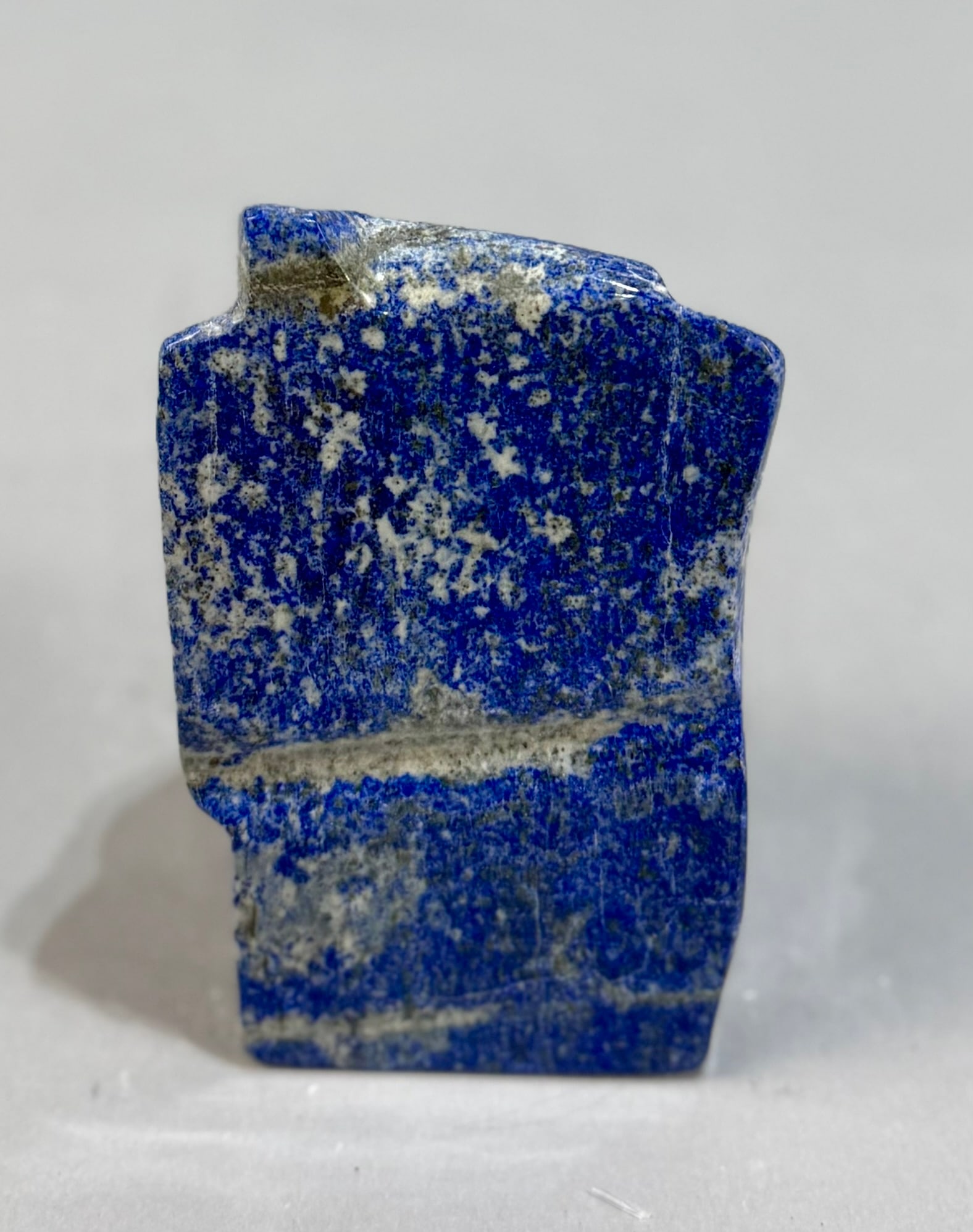 Polished Lapis Lazuli Freeform: High grade, finely polished lapis lazuli freeform from Afghanistan. 5.5” x 3” x 2”. 2 lbs, 12 oz.