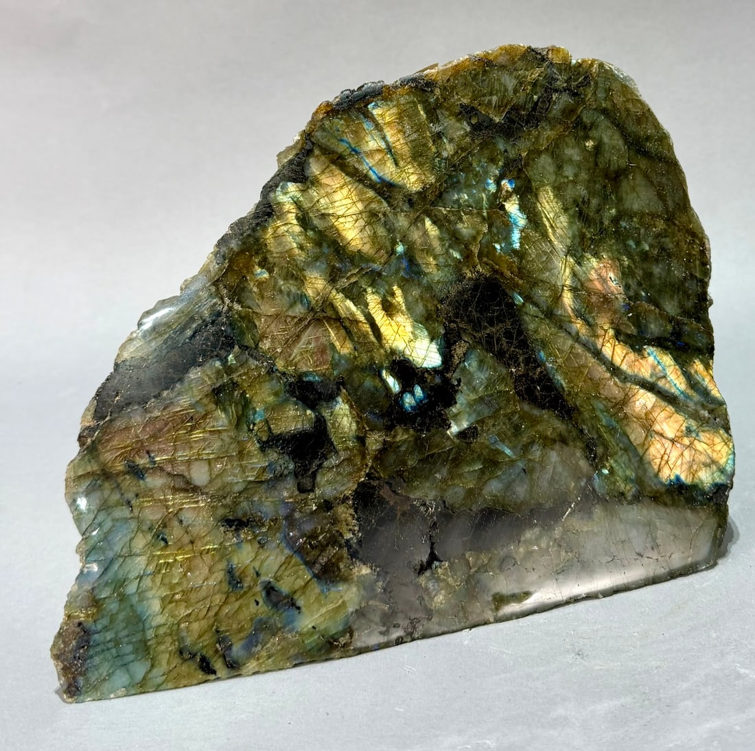 Live Edge Labradorite Freeform: Large, live edge, front-polished labradorite freeform from Madagascar. 7" x 9.25” x 5.5". 12 lb, 2 ounces.