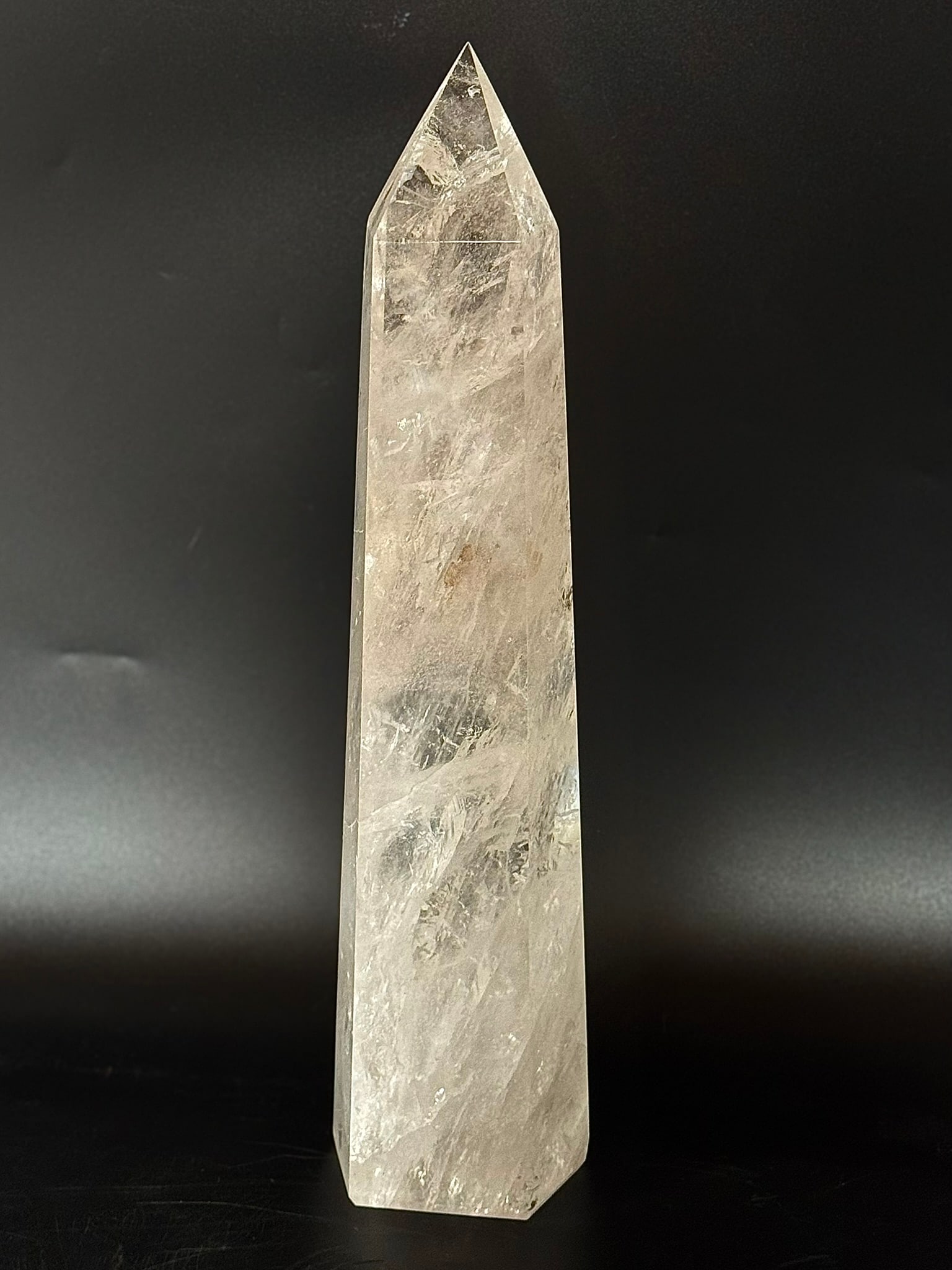 Huge Clear Quartz Crystal Obelisk With Inclusions: Huge clear quartz crystal obelisk with refracting inclusions from Brazil. 15.5” x 3.5” x 3”. 8 lbs, 5 oz.