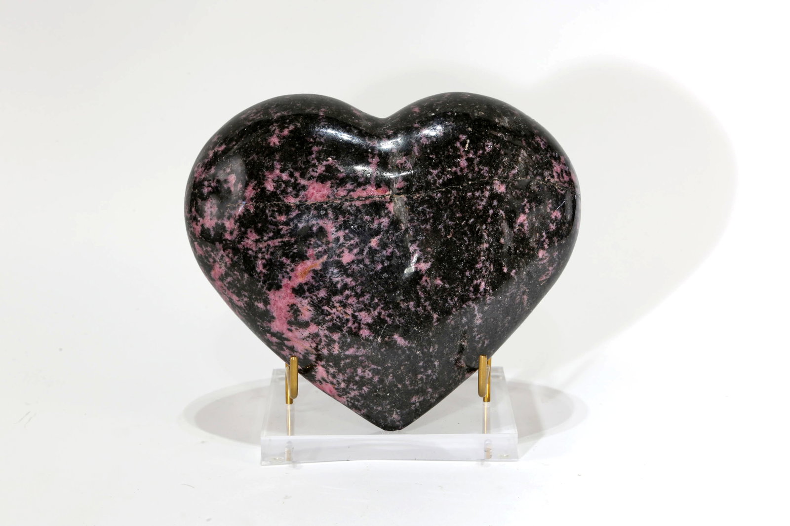 Polished Rhodonite Heart: Polished rhodonite heart from Madagascar. 5.5" x 6.5" x 2". 4 lbs, 14 oz.