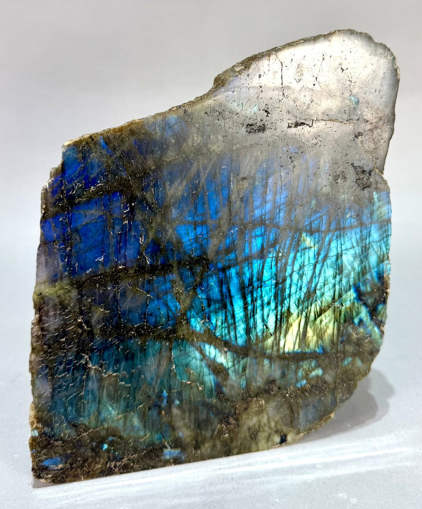 Live Edge Labradorite Freeform: Large, live edge, front-polished labradorite freeform from Madagascar. 6.75" x 8” x 4". 11 lb, 10 ounces.