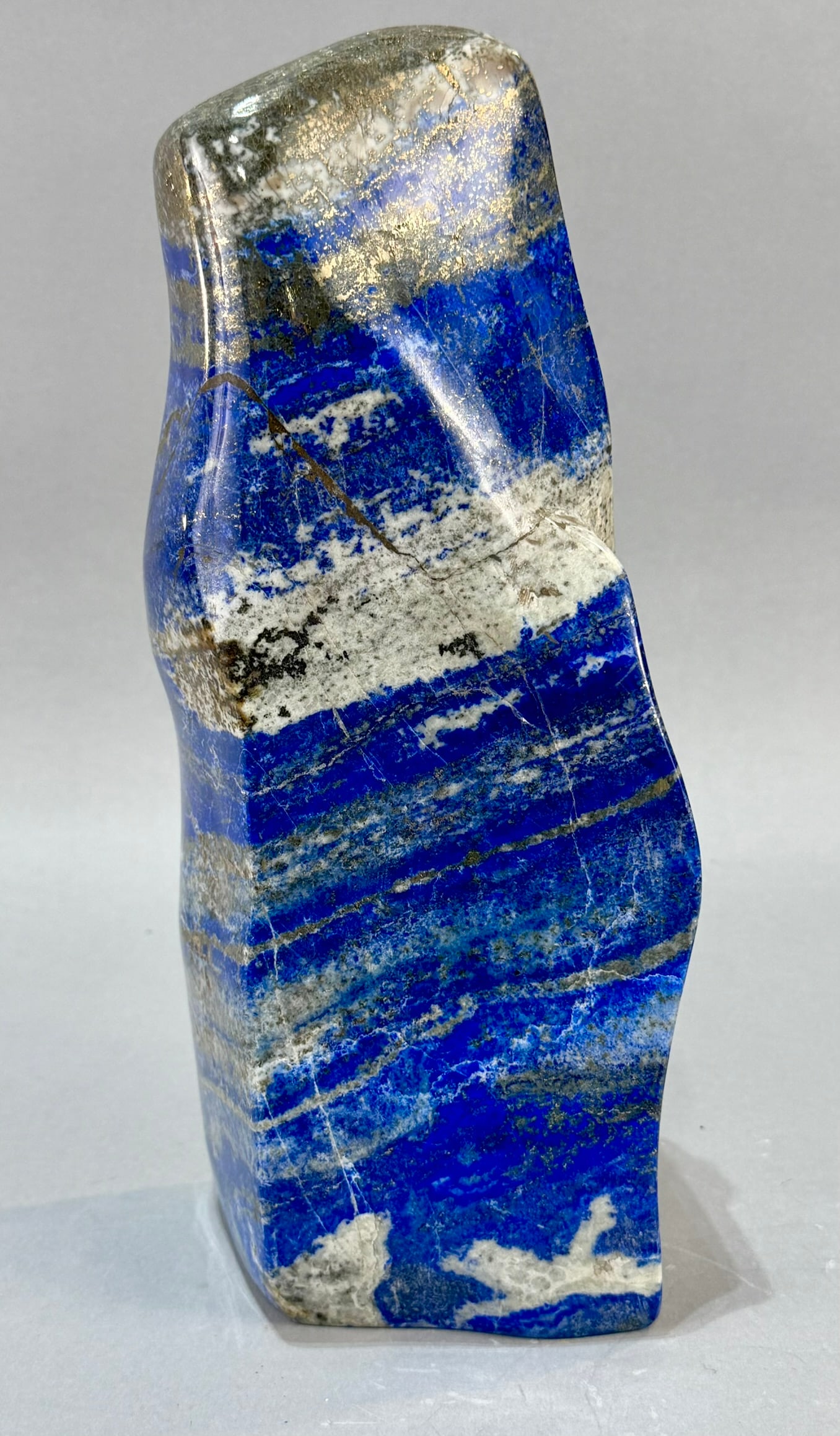 Polished Lapis Lazuli Freeform: High grade, finely polished lapis lazuli freeform with pyrite and calcite streaking from Afghanistan. 11.5" x 4" x 3.5". 11 lb, 2 ounces.