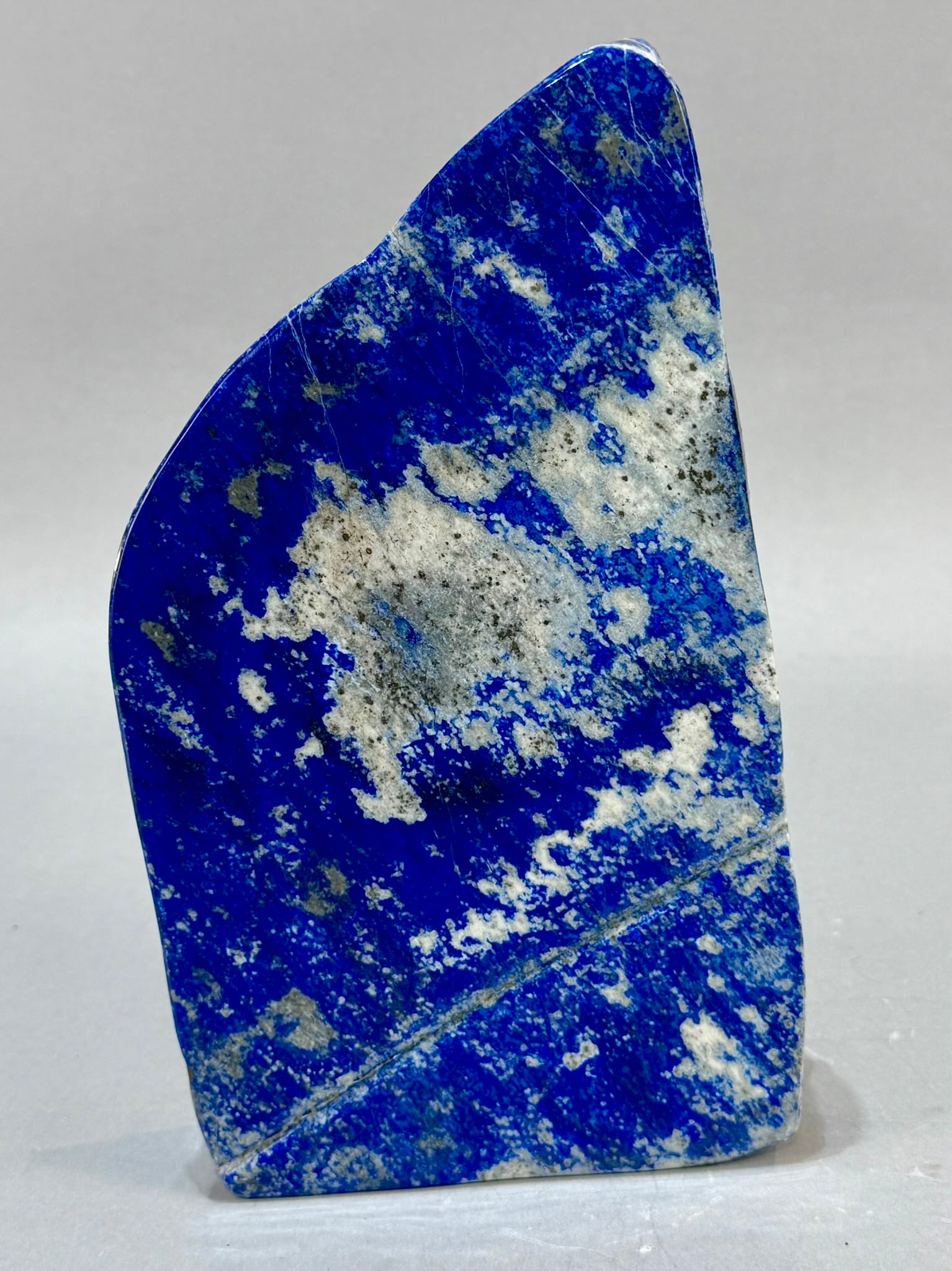 Polished Lapis Lazuli Freeform: High grade, finely polished lapis lazuli freeform from Afghanistan. 9.5" x 5.5" x 1.5". 6 lb, 1 ounce.