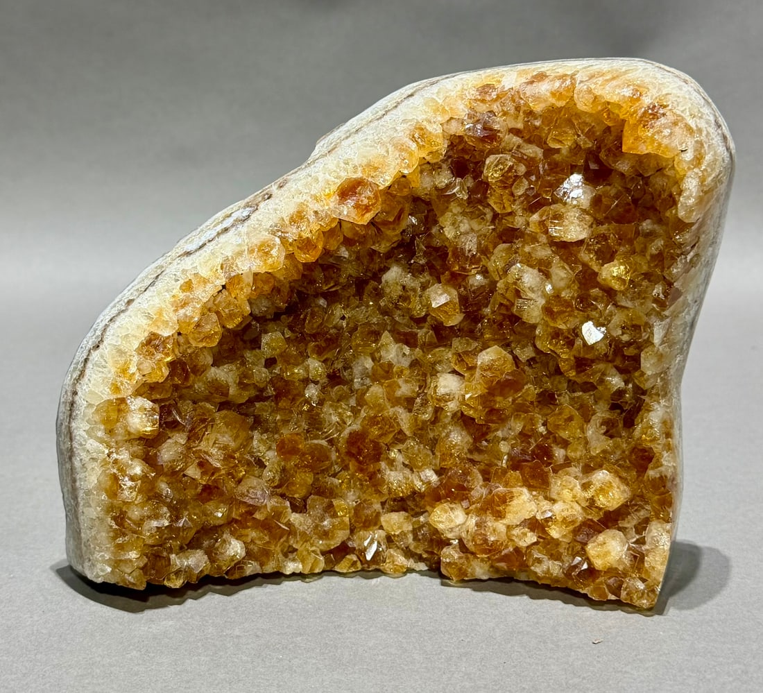 Citrine Cluster: Freestanding citrine cluster with polished edges and calcite crystals. 6.25" x 7.5" x 3". 7 lbs.