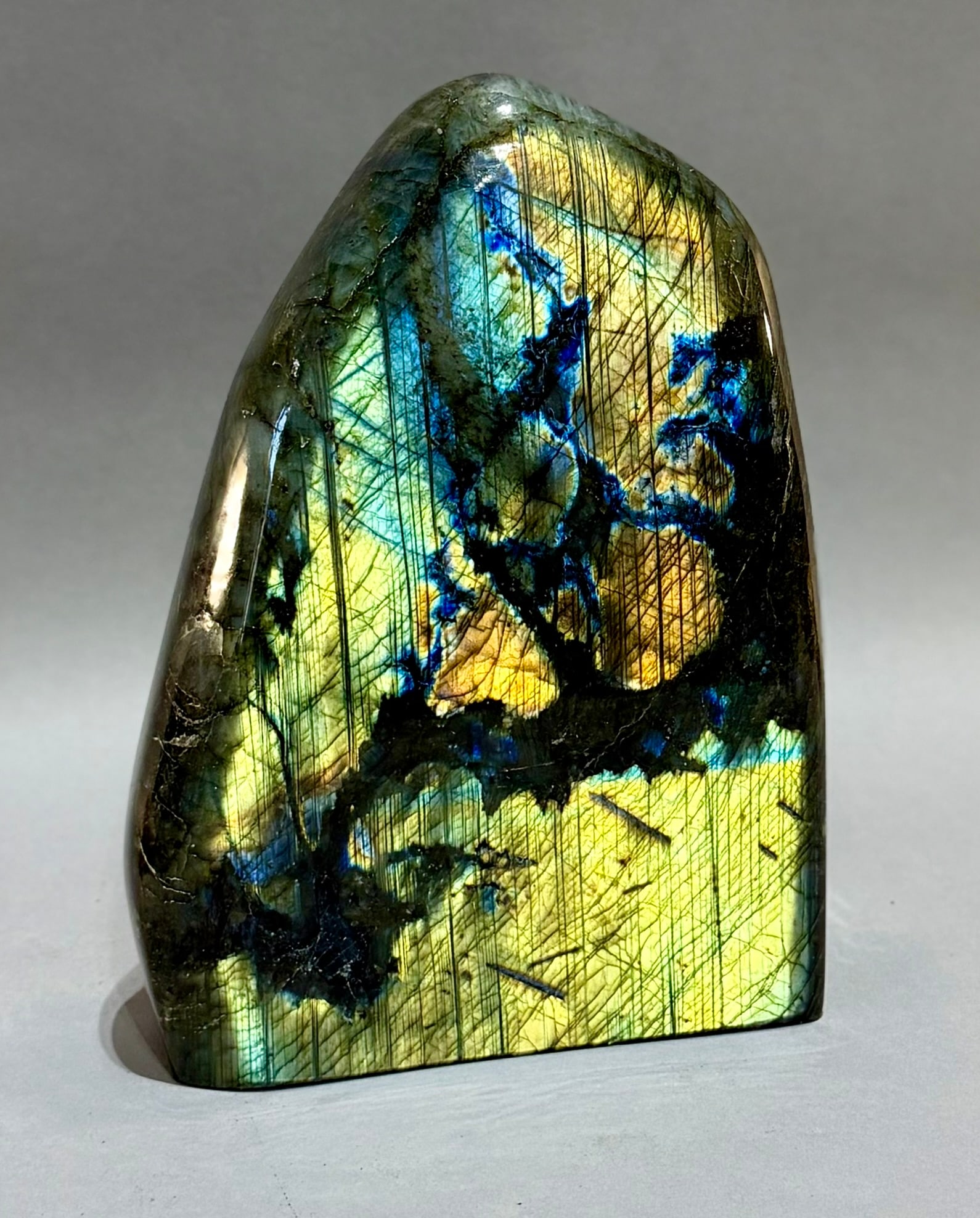 Large Polished Labradorite Freeform: Large, polished, highly-reflective labradorite freeform from Madagascar. 9.25" x 6.75” x 2.25". 10 pounds, 8 ounces.