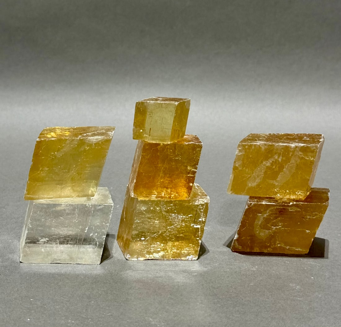7 Optical Calcite Iceland Spar Rhomboid Formations: Group of 7 optical calcite/Iceland spar rhomboid formations. 1.34 pounds.