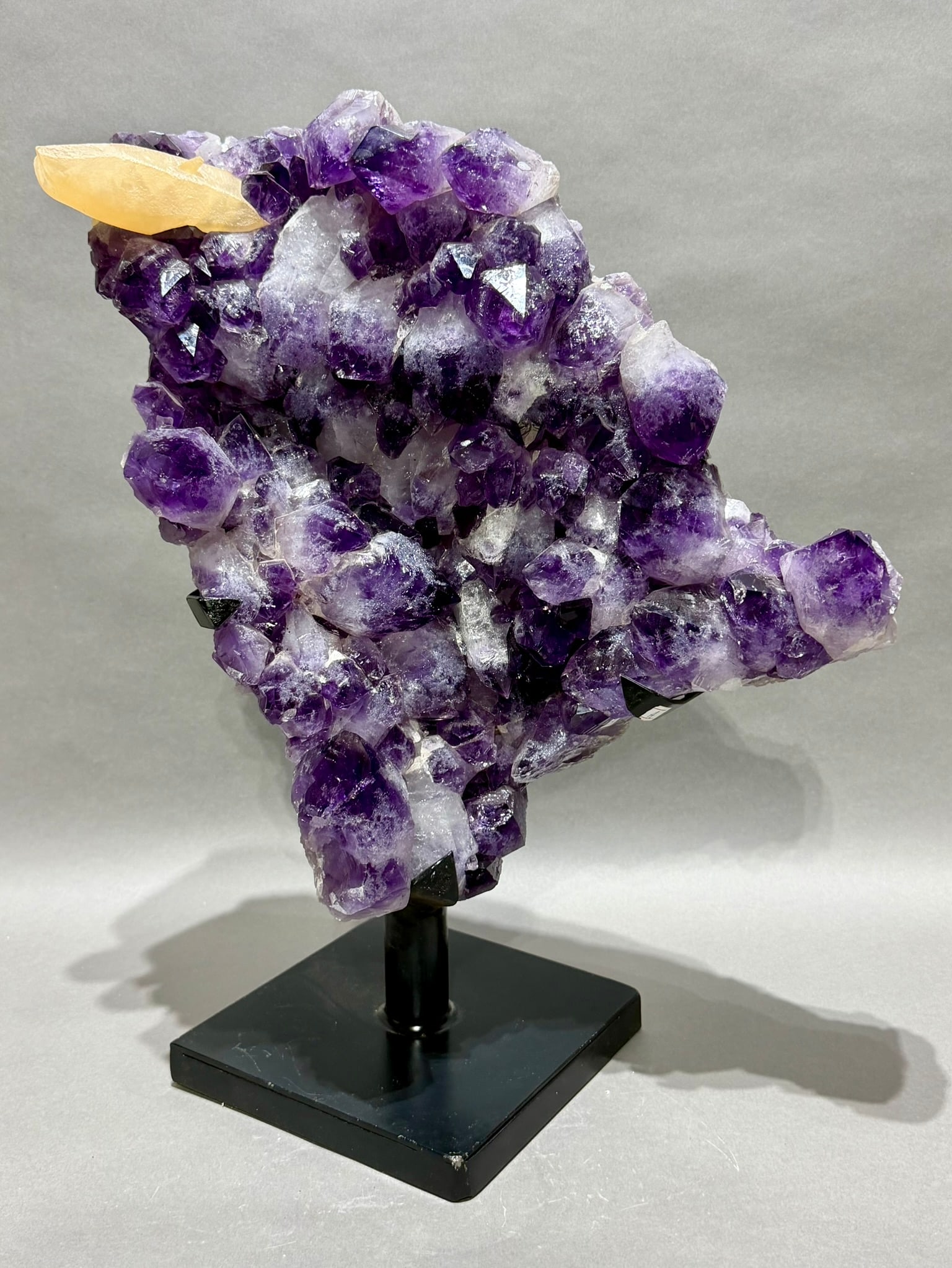 Large Amethyst Formation wIth Calcite on Custom Stand: Large amethyst formation with large dark crystals and calcite point on custom metal stand. 18.5" x 15" x 9". 26.4 pounds.
