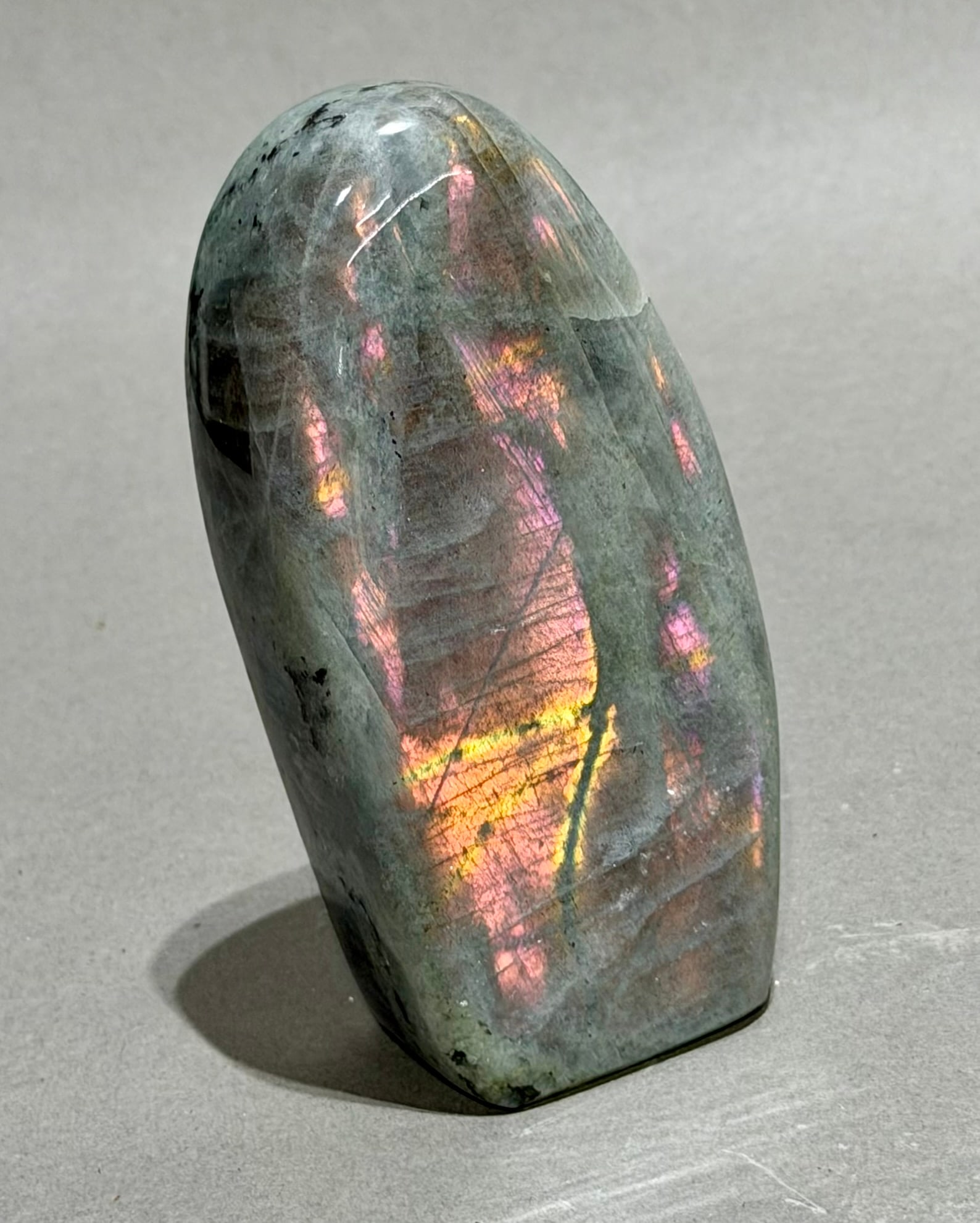 Pink and Purple Labradorite Freeform: Pink and purple labradorite freeform from Madagascar. 4.5" x 2.25" x 1.25". 1.06 pounds.
