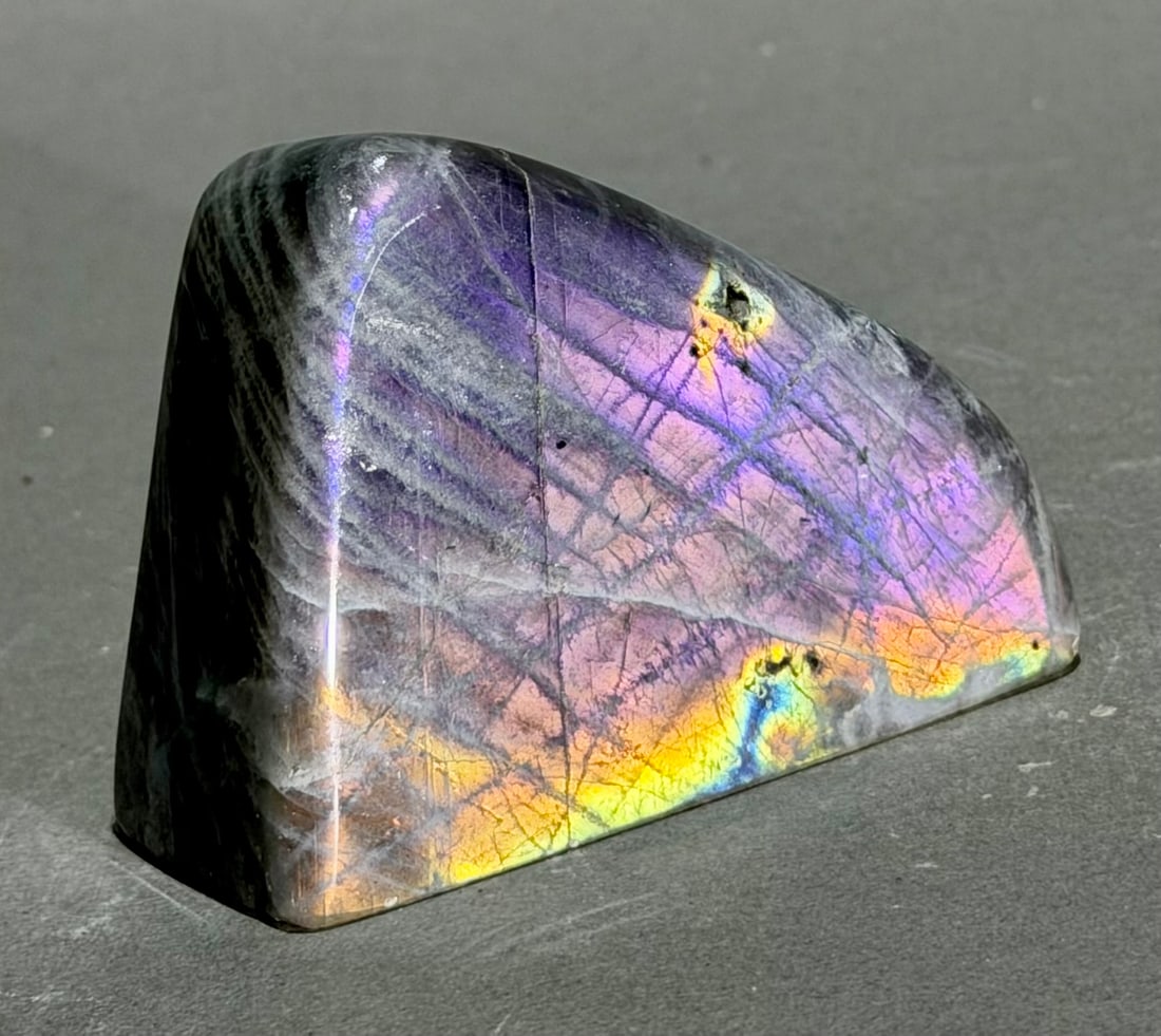 Pink and Purple Labradorite Freeform: Pink and purple labradorite freeform from Madagascar. 2.5" x 3.5" x 1.5". .82 pounds.