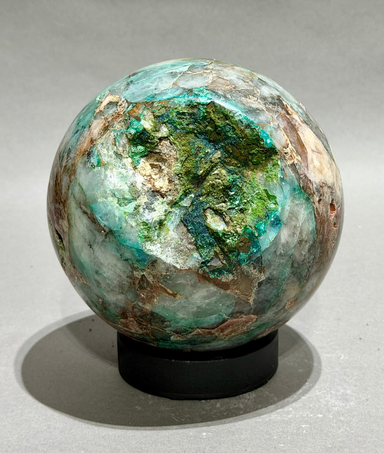 Rare Chrysocolla, Hematite and Quartz Sphere: Rare fluorescent chrysocolla, hematite, and quartz sphere from the Tentadora Mine in Peru. 5.5" x 5.5" x 5.5". 8.1 pounds.