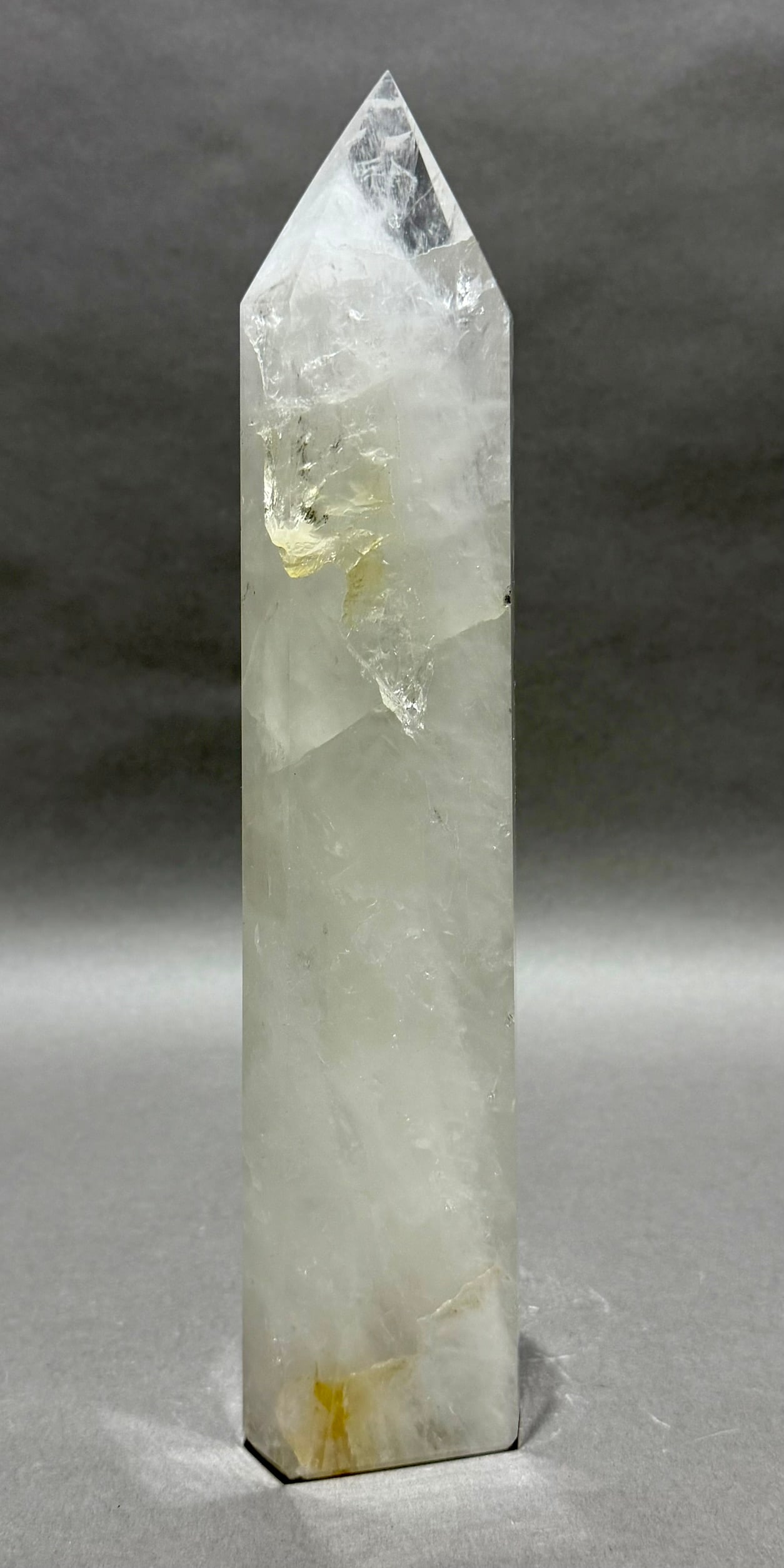 Quartz Crystal Obelisk With Inclusions: Quartz crystal obelisk with refractive inclusions from Brazil. 12” x 2.75” x 1.5”. 3.62 lbs.