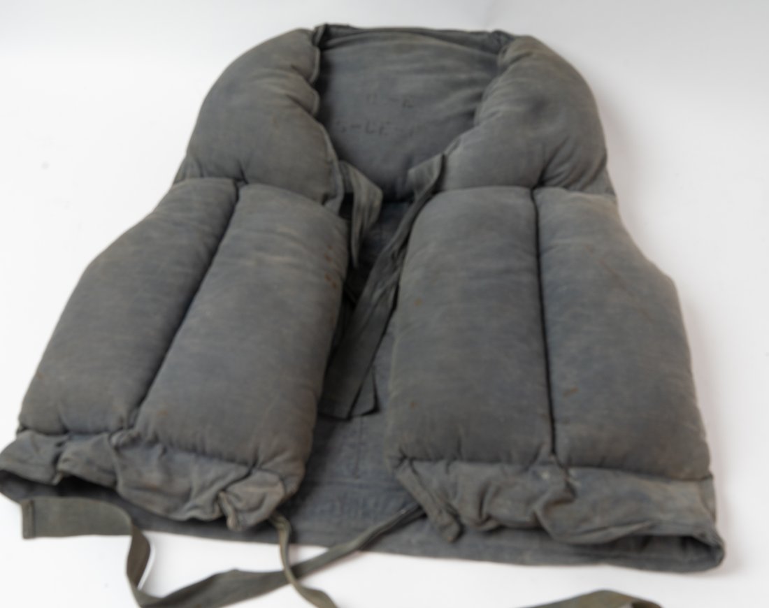 WWII Merchant Marine Kapok Life Vest Dated 1941.: U.S. Approved and inspected by the Bureau of Marine and Inspection Navigation ink stamped "March 18, 1941" Made by the American Pad & Textile Co. The letters "E G" are also painted to the back. These 