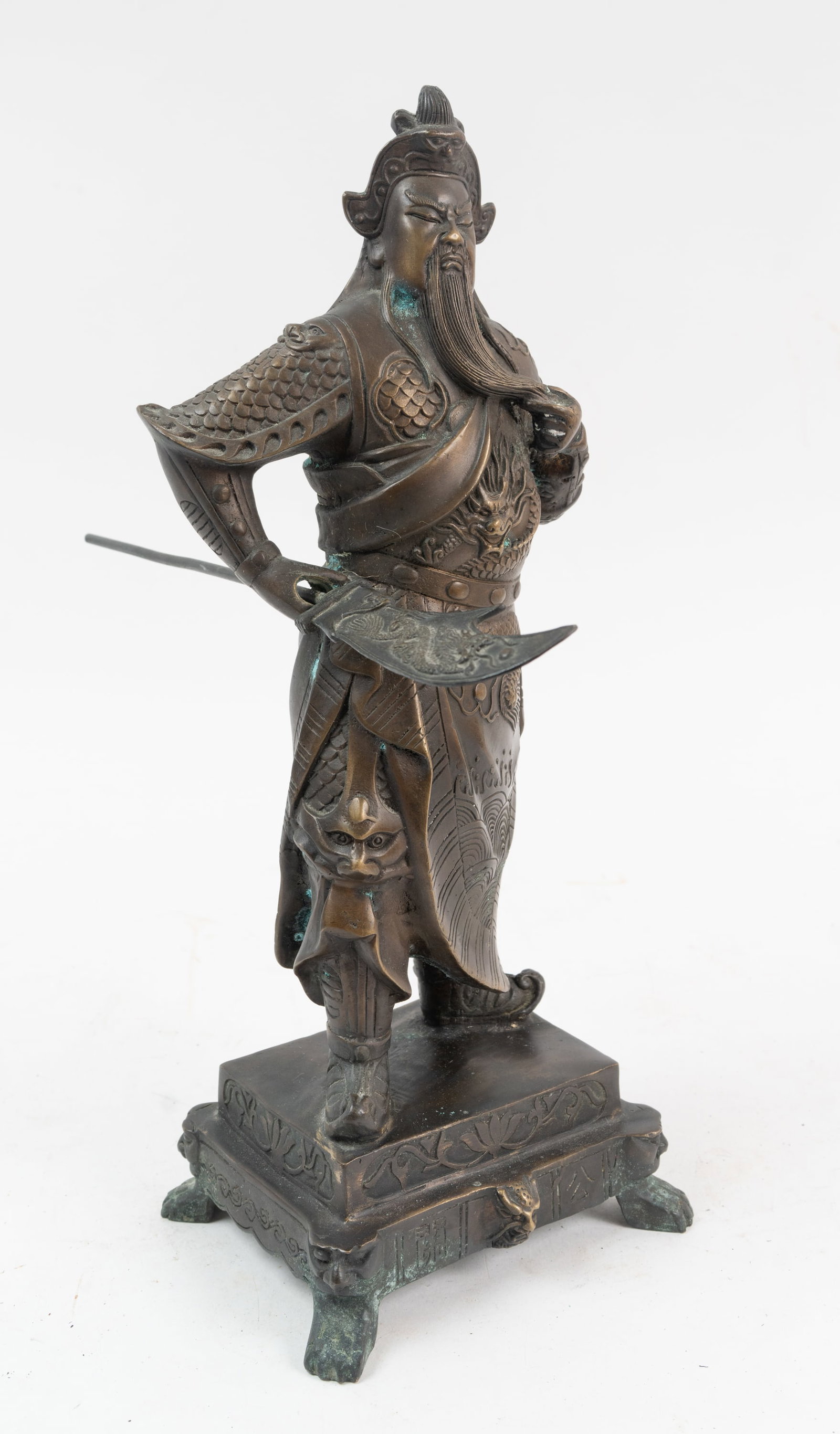 Antique Chinese Bronze Warrior Statue.: A soldier holding a long pole sword arm that can be removed from the statue. A nice form having a dragon design on both the sword and the battle dress gown. Much detail throughout and an impressive po