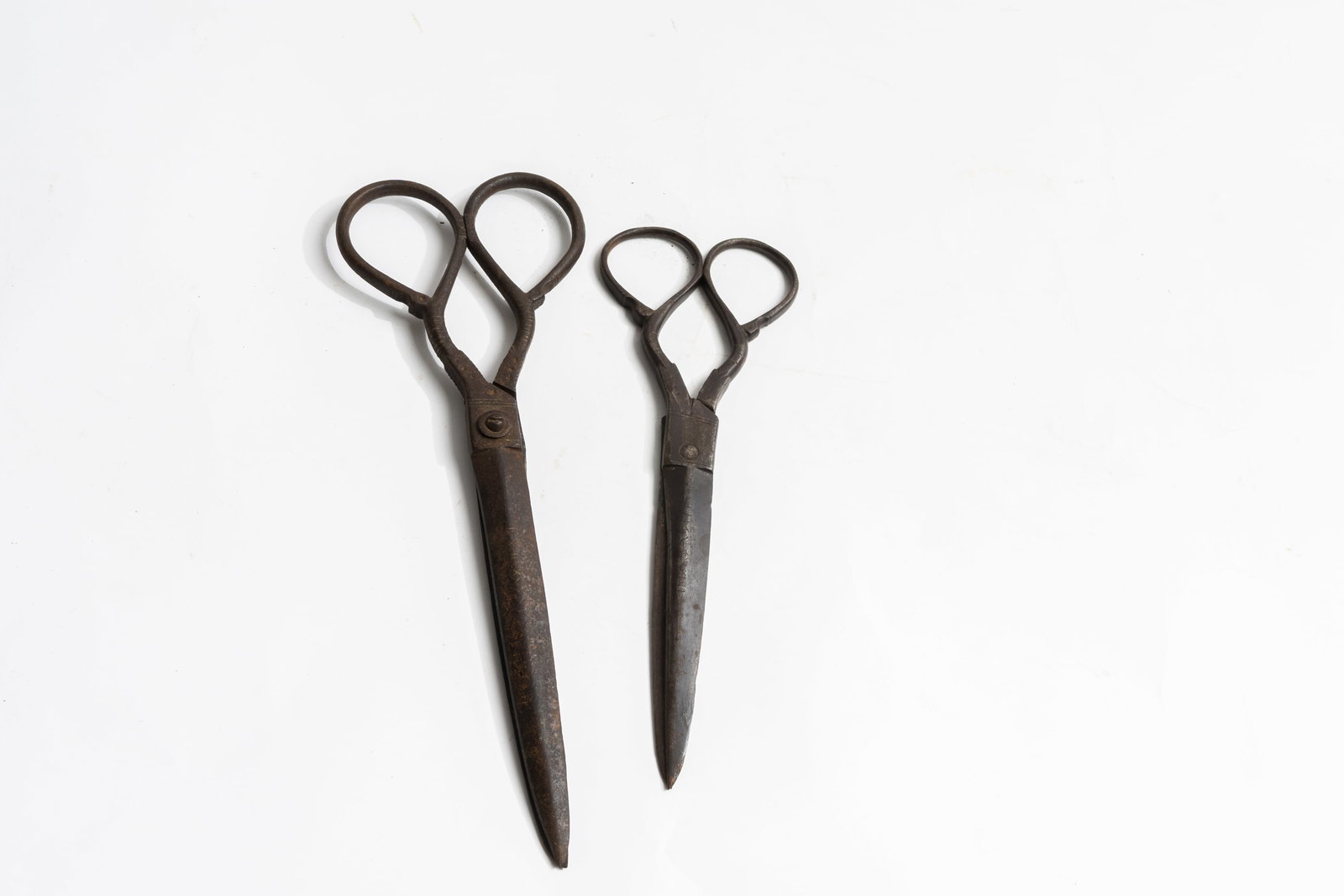 Lot of Two Middle Eastern Antique Scissors with Inlay.: Each has designs on the tops of the blades and on the handles. Remnants of brass in some of the inlay. Large one measures 10-1/2" long and small pair measures 9" long.
