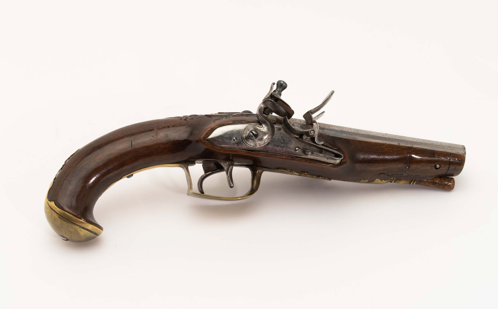 18th-C Double Barrel Flintlock Pistol.: Ornate stock carving at barrel tang with brass furniture. Barrels are engraved at breech plug and tang. Flint locks measure 3-1/2" x 3/4" and function properly, hammer and jaw screws are blued. Barrel