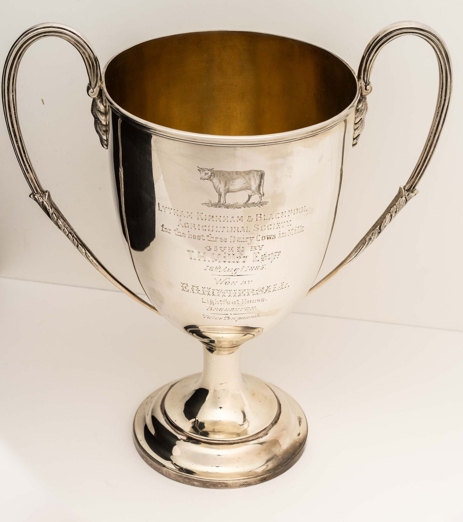Large Silver Best Three Dairy Cows Trophy 1885.: Traditional form with an engraved Cow and a presentation inscription having english hallmarks of Charles Stuart Harris. Also stamped on the bottom "Munday 6 Ct. Portland St." Interior has a gold wash