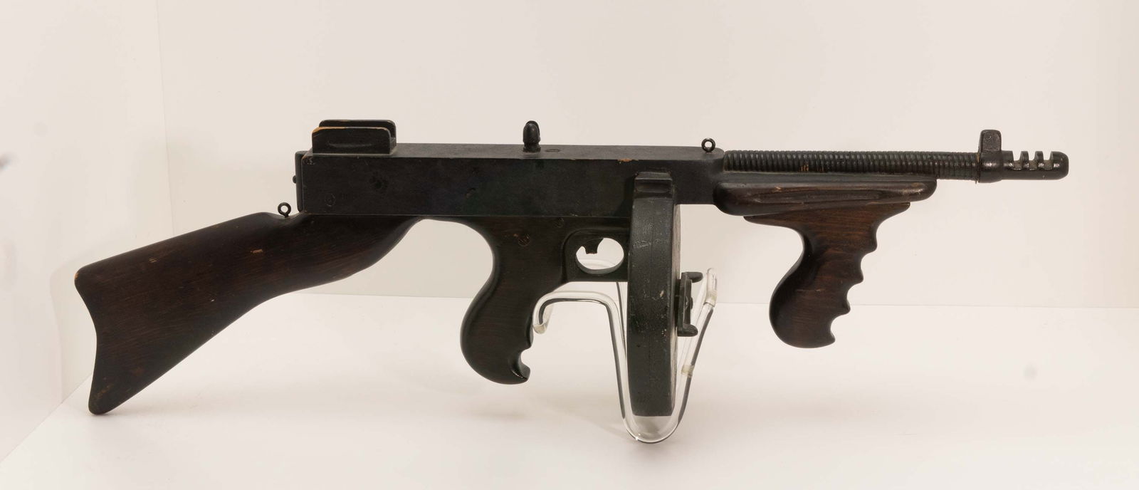 Antique Wood Thompson Machine Gun Folkart Toy.: An old wood life sized replica of a prohibition era Thompson Machine Gun with heavy wood grain in the stock, trigger handle, and front forward grip. The frame body is very old alligator scale aged bla