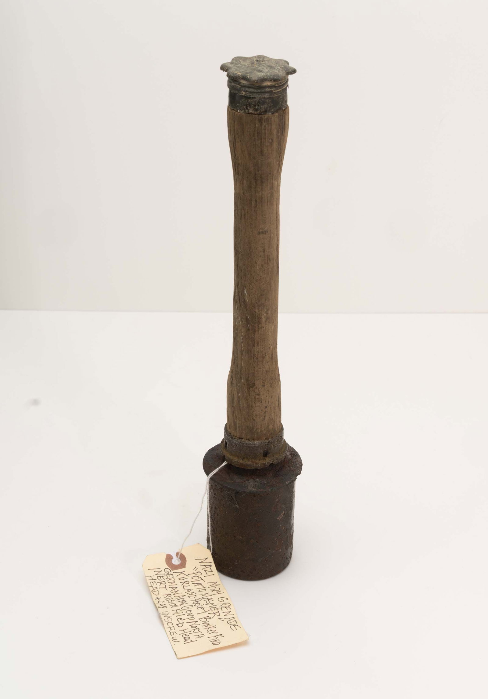 WWI Era German Stielhandgranate Potato Masher.: Inert M17 or M24 type that appears to be a battlefield pick up due to the note inside the head that reads "Nazi M-24 Grenade Potato Masher Kurland Pocket Bunker Find German Army Group North. Inert Res