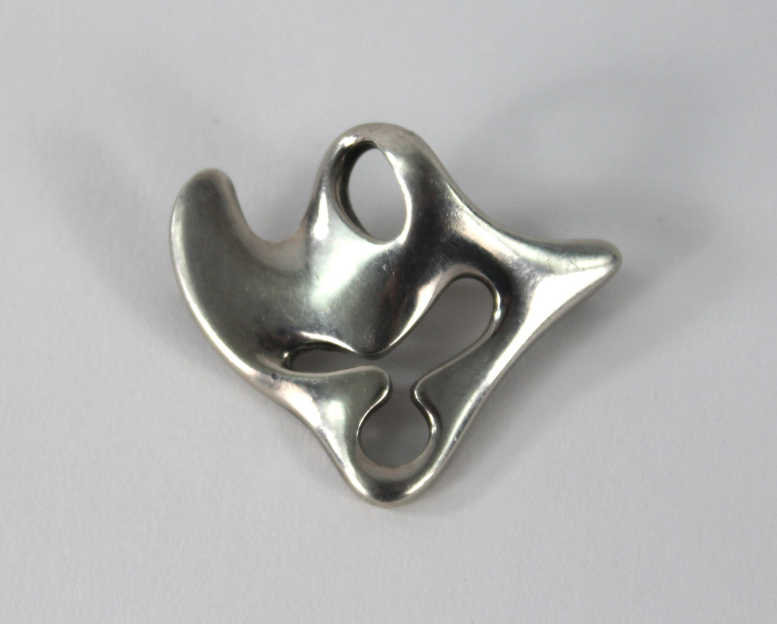Henning Koppel for Georg Jensen Silver Brooch: Sterling silver brooch of organic form designed by Danish artist Henning Koppel for Georg Jensen. Weight as sits .85ozt. Approx. 1 3/4" x 1 1/2". Marked "Georg Jensen Sterling Denmark" on back.