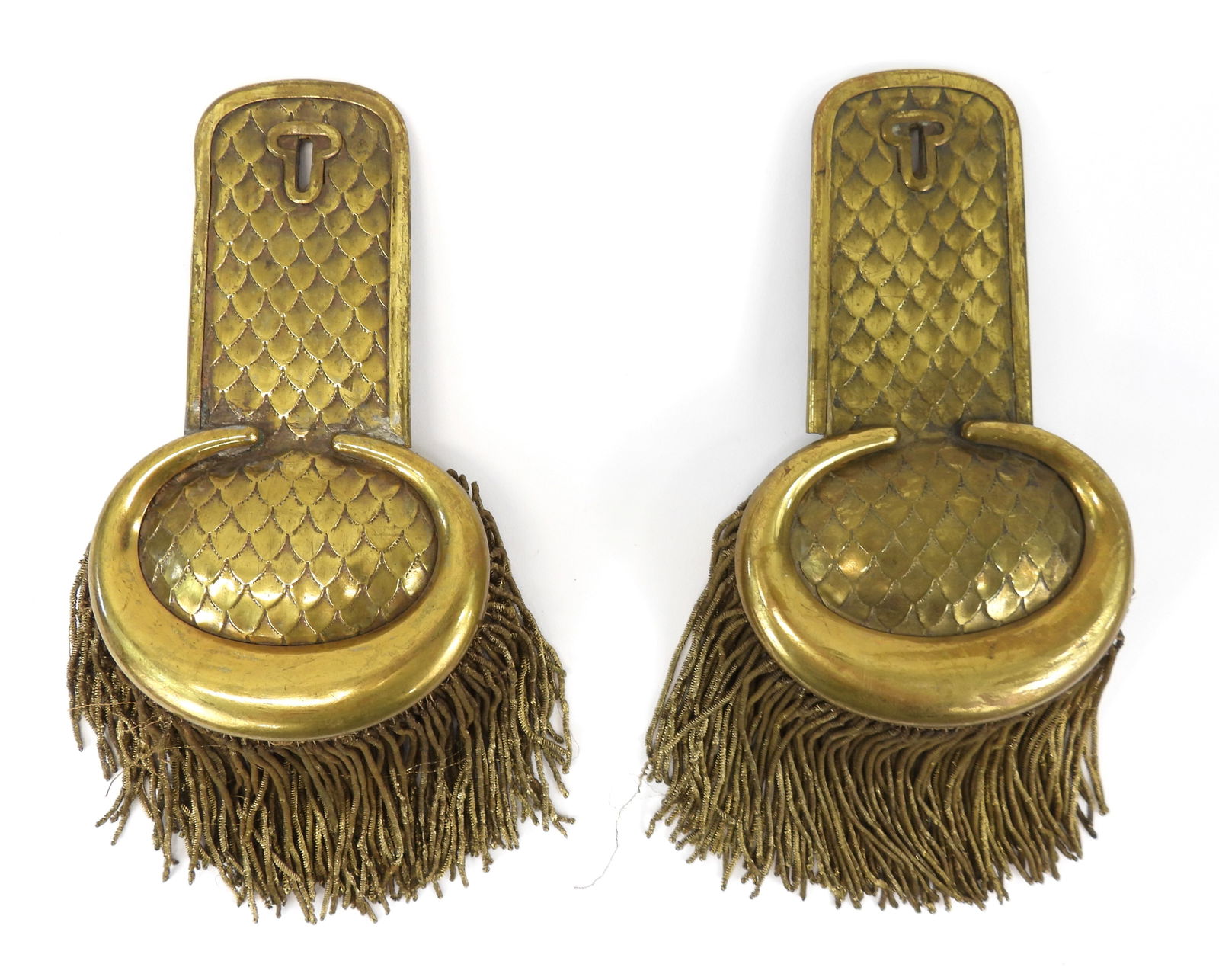 Continental Brass Epaulets: Brass epaulet with stamped scales on the body, applied border and key/hole, bullion fringe, padded pillows on the underside, and steel attachment tabs. Overall lg. 7 1/2"