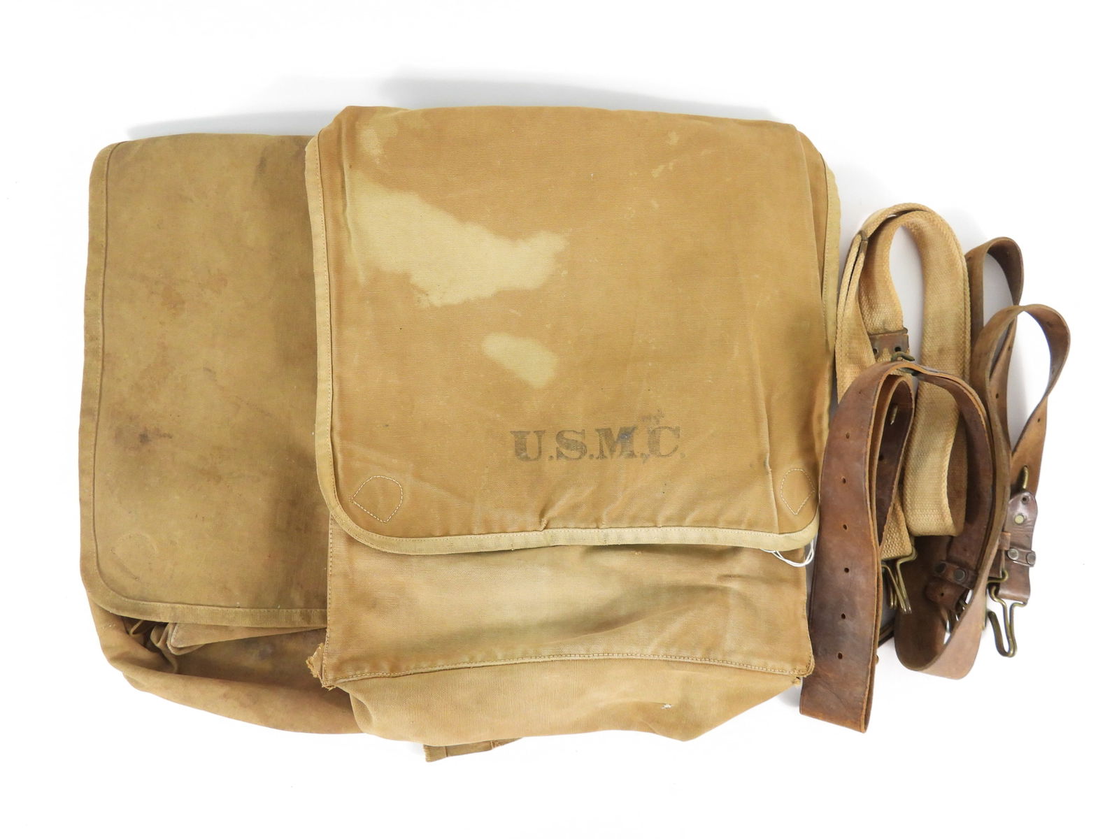 Group of USMC Spanish-American War-era Gear: Two Spanish-American War-era haversacks marked "U.S.M.C." on the covers; a canvas Kerr strap with brass hooks; and three leather haversack straps.