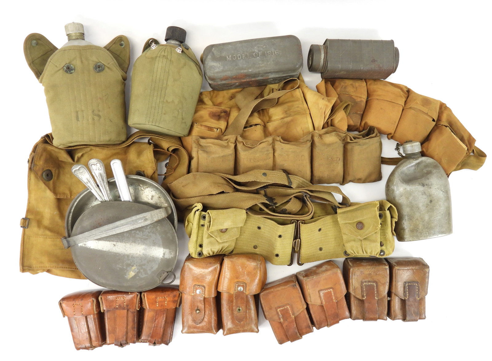 Group of WWI and WWII Gear: Three canteens (one 1962-dated); four leather ammunition pouches; a WWI gas mask bag; one WWI mess kit with fork, spoon, and knife; a WWI bacon tin; a WWI condiment can; an eagle snap canteen cover; t