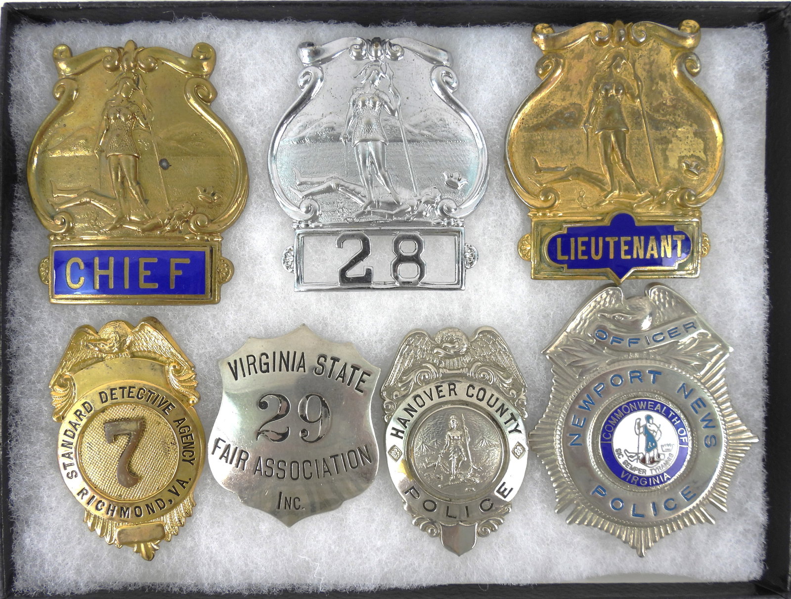 Seven Virginia Police Badges: A screw-back gold cap badge with "CHIEF" in blue enamel (missing the nut on the back); a screw-back silver cap badge with "28" on the bottom; a screw-back gold cap badge with "LIEUTENANT" in blue enam