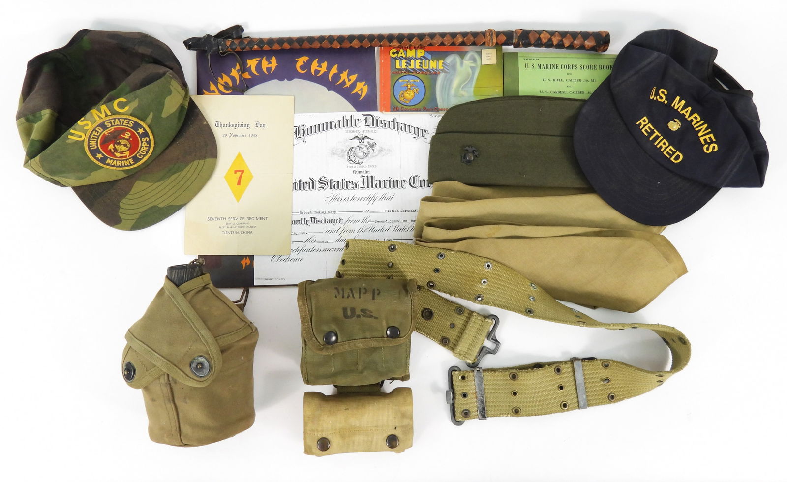 African-American USMC Sgt. Robert W. Mapp Grouping: USMC canteen, cup, and cover; an overseas cap with eagle, globe, and anchor; four ties; a pistol belt with a medical kit and first aid pouch; a crop/knife; a rifle score book; a Camp Lejeune postcard