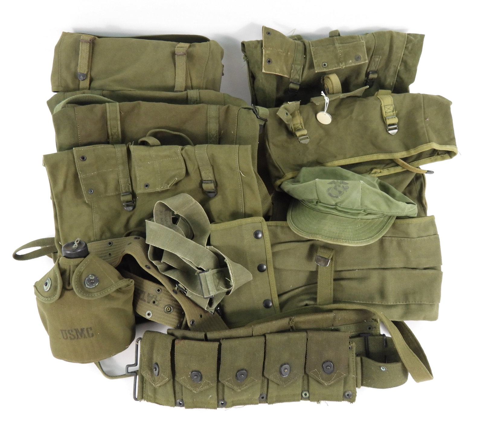 Group of Korean War-era USMC Gear: A 1952-dated ten pocket ammunition belt marked "U.S.M.C."; a pistol belt marked "U.S."; a canteen, cup, and cover marked "USMC" on the front and "COLLETTE/MFG. CO./1952'; a 1952-dated upper and lower