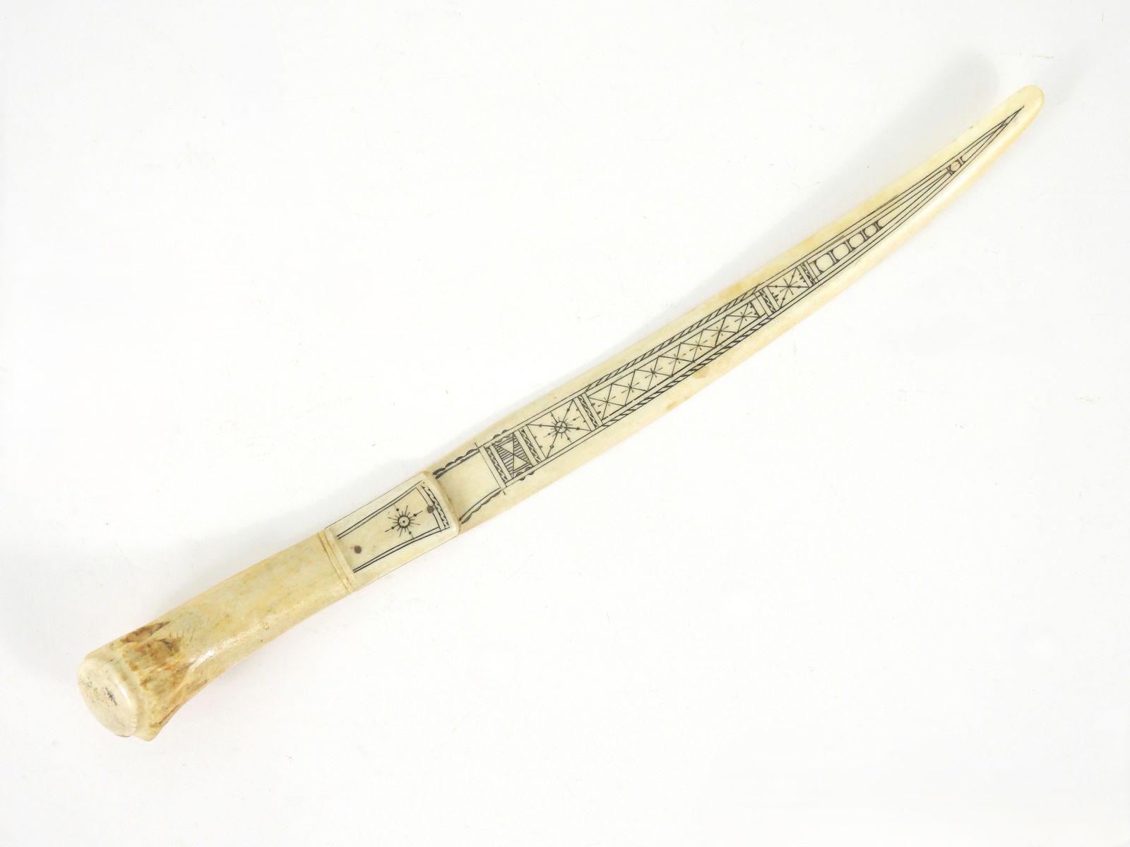 Antique Engraved Antler Letter Opener: 19th Century. Nicely formed antler and bone knife style letter opener with geometrical scrimshaw designs. Origin unknown but well done. From a Massachusetts collection. 11 1/2" x 5/8"